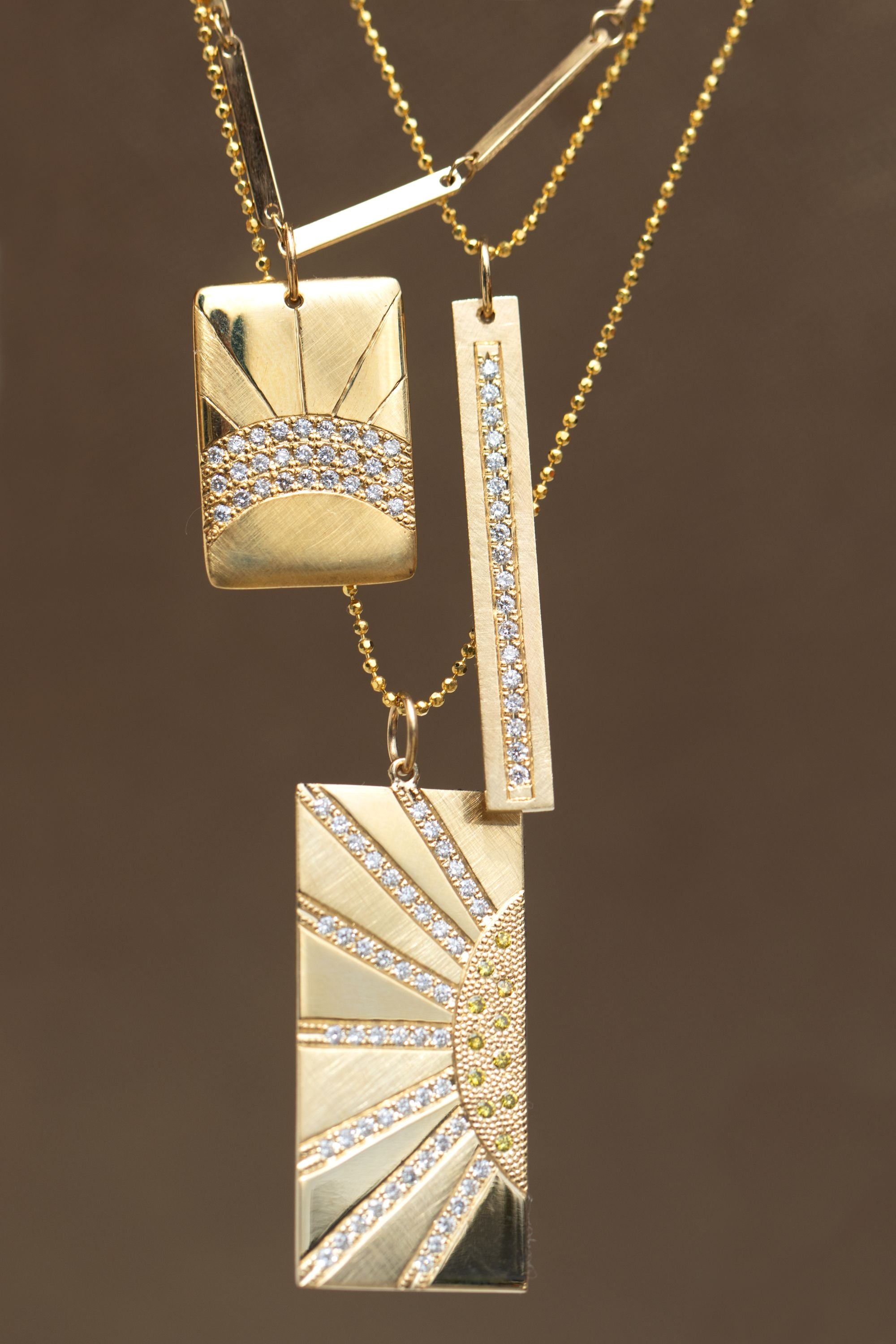 14k yellow gold vertical bar pendant with paved set white diamonds on diamond cut ball chain paired with cayy and hott pendant stacked with doey chain in still shot