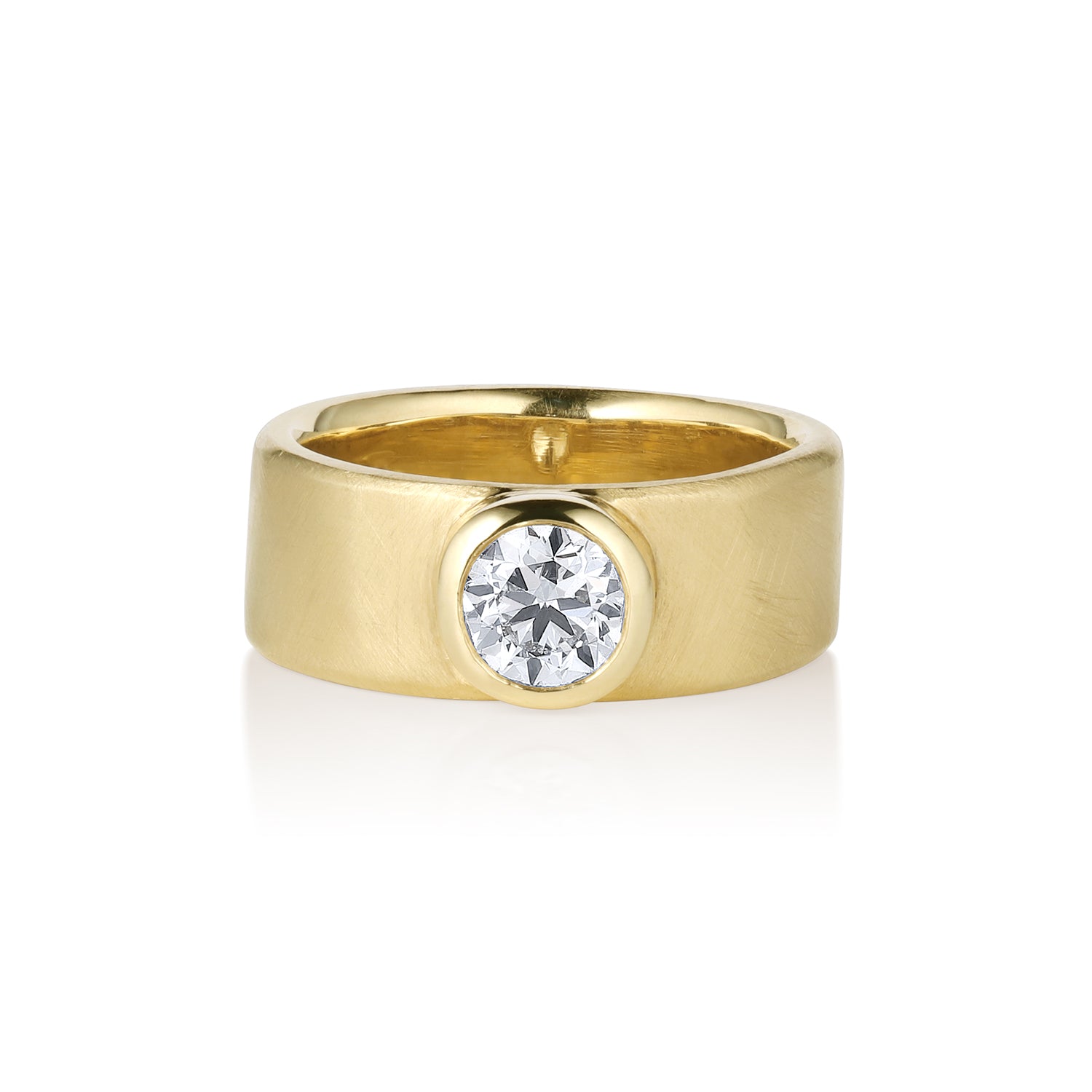 Wide band comfort fit gold ring with a single stone round white diamond in bezel setting shown on a white background