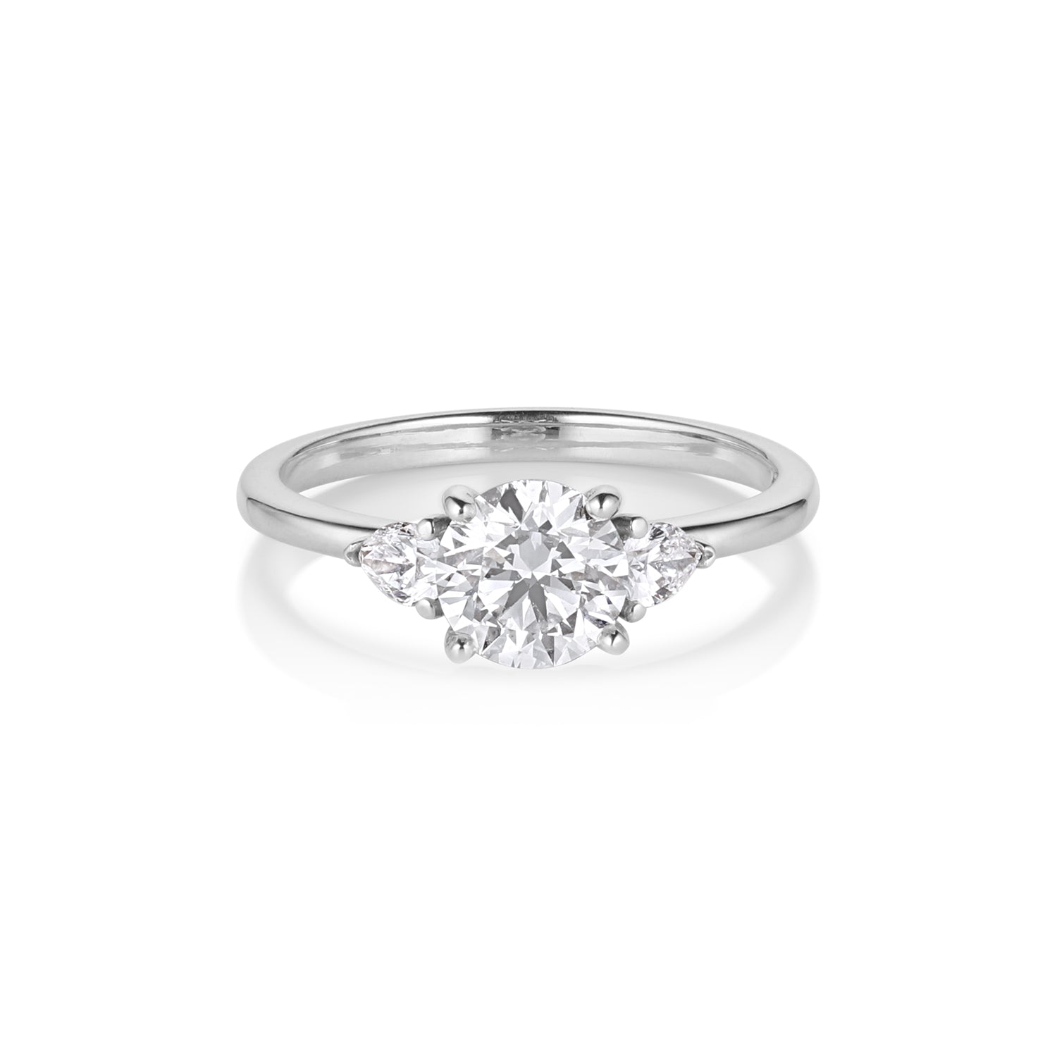 3 stone engagement ring in white gold with trillion side stones and round center white diamond on white background