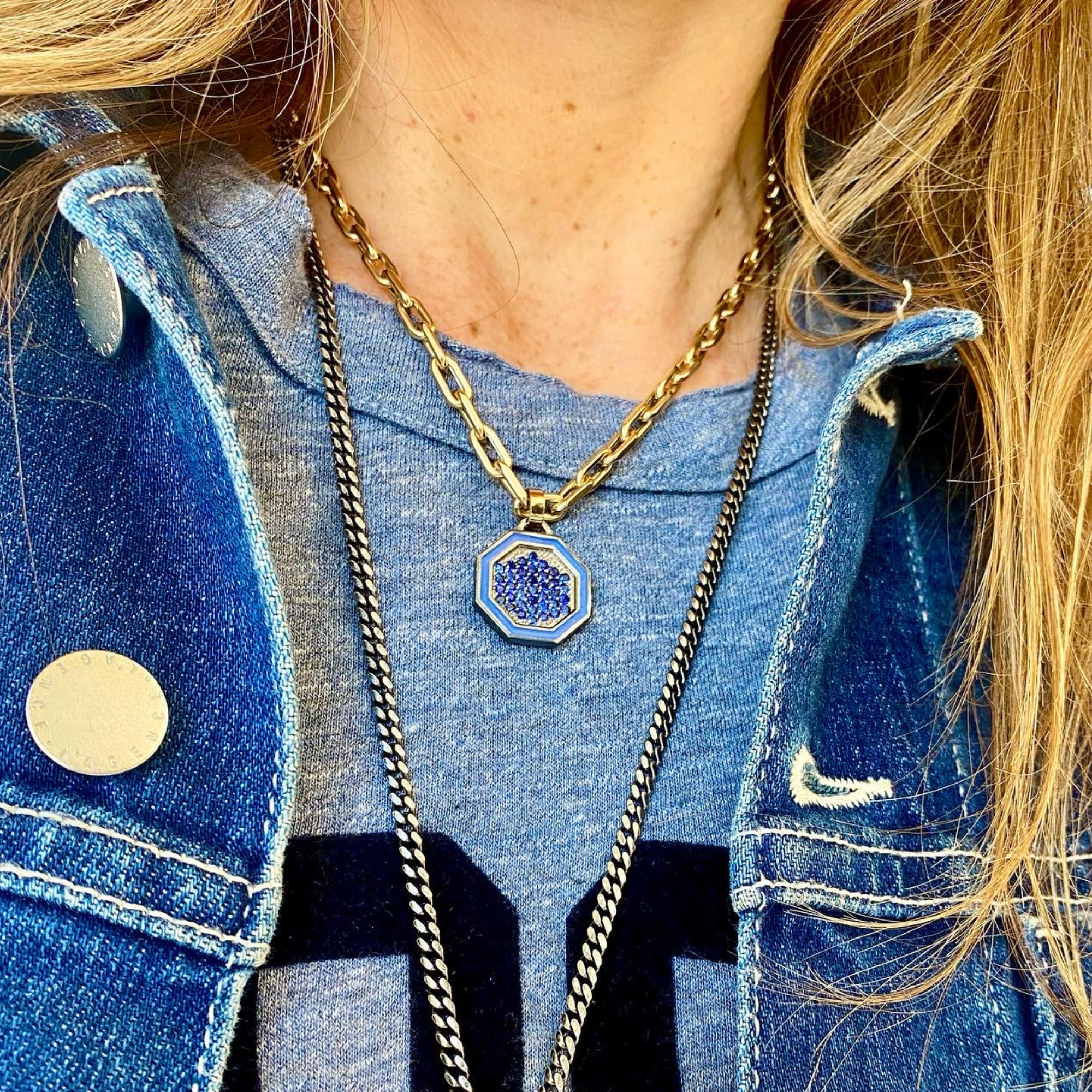 Image of a chunky hexagon sterling silver blue sapphire and enamel pendant lifestyle shot worn on a model.