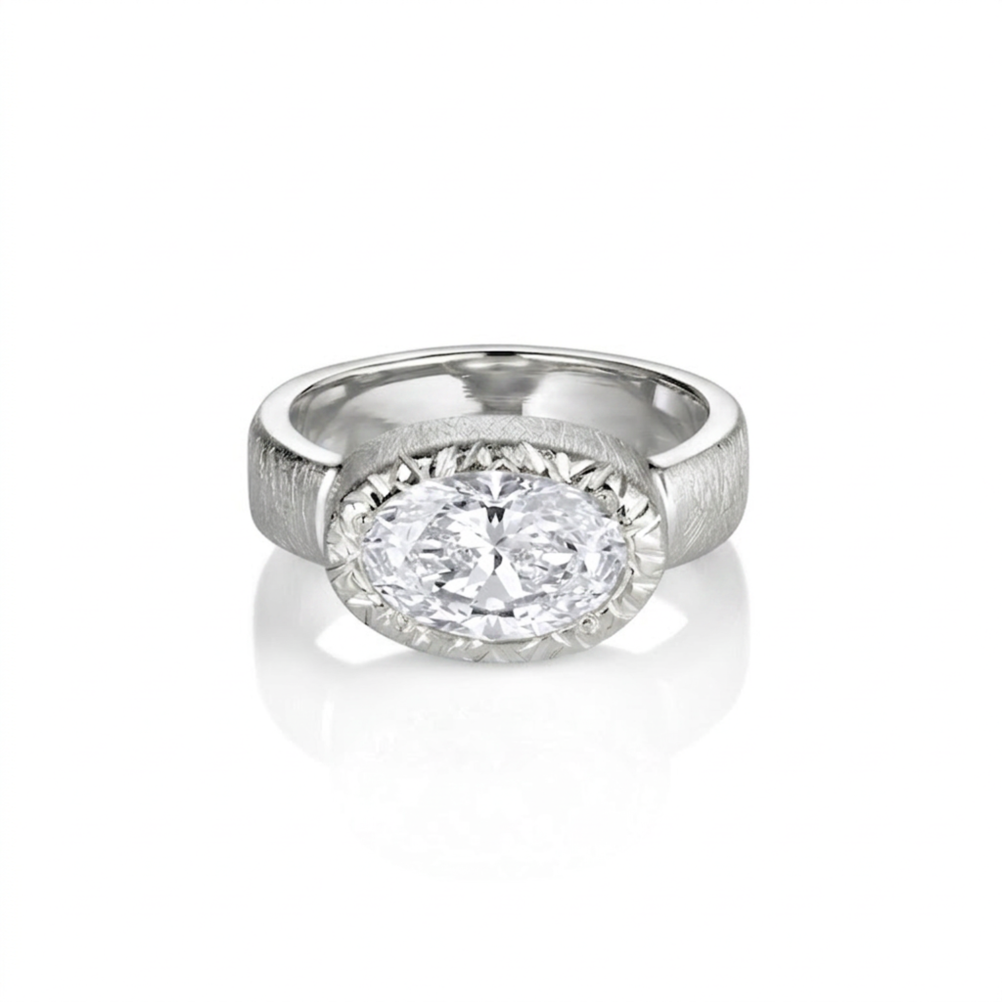Chunky wide band east-west oval bezel solitaire diamond engagement ring with textured finish in 14k white gold on a white background