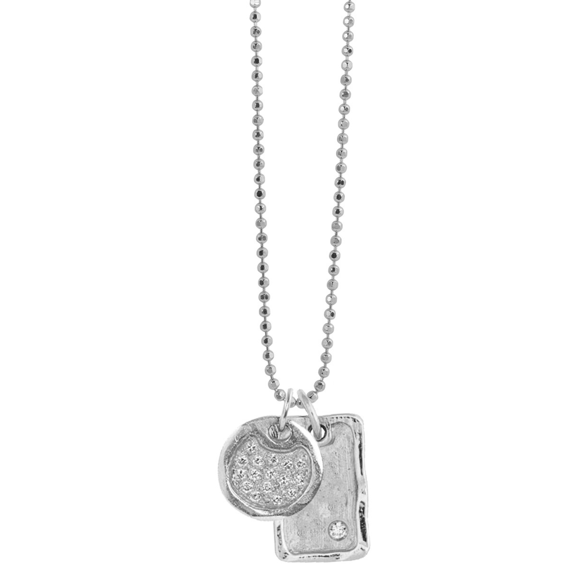 14k white gold round pendant with beaded texture and scattered white diamonds paired with rectangle pendant with offset white diamond on diamond cut ball chain on white background