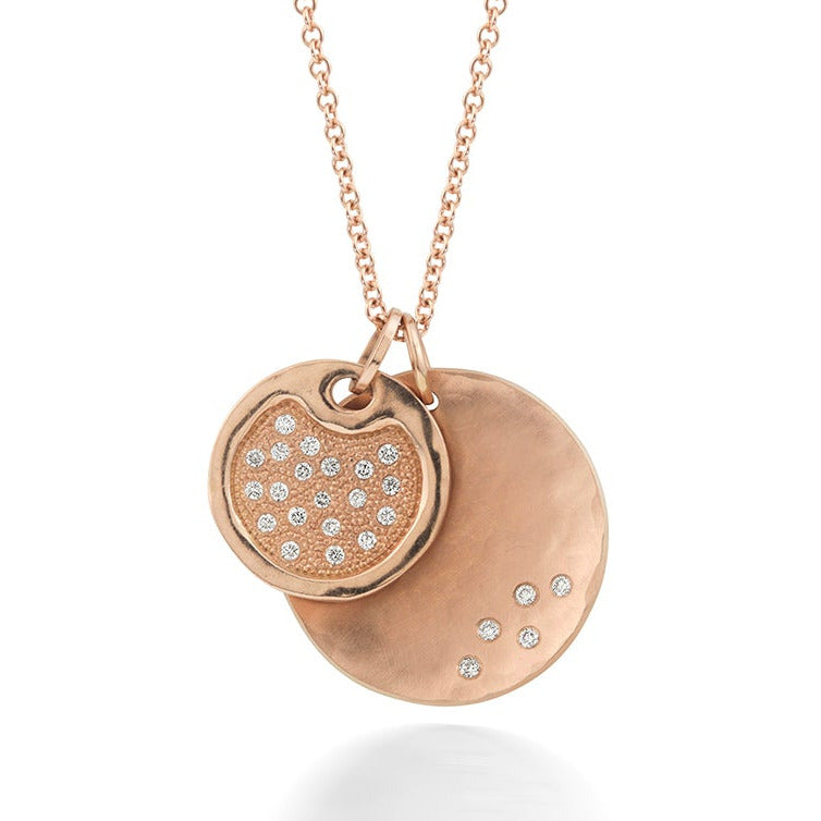 14k rose gold white diamond accents round medallion and disk pendants hanging on rolo chain gold necklace on a white background
