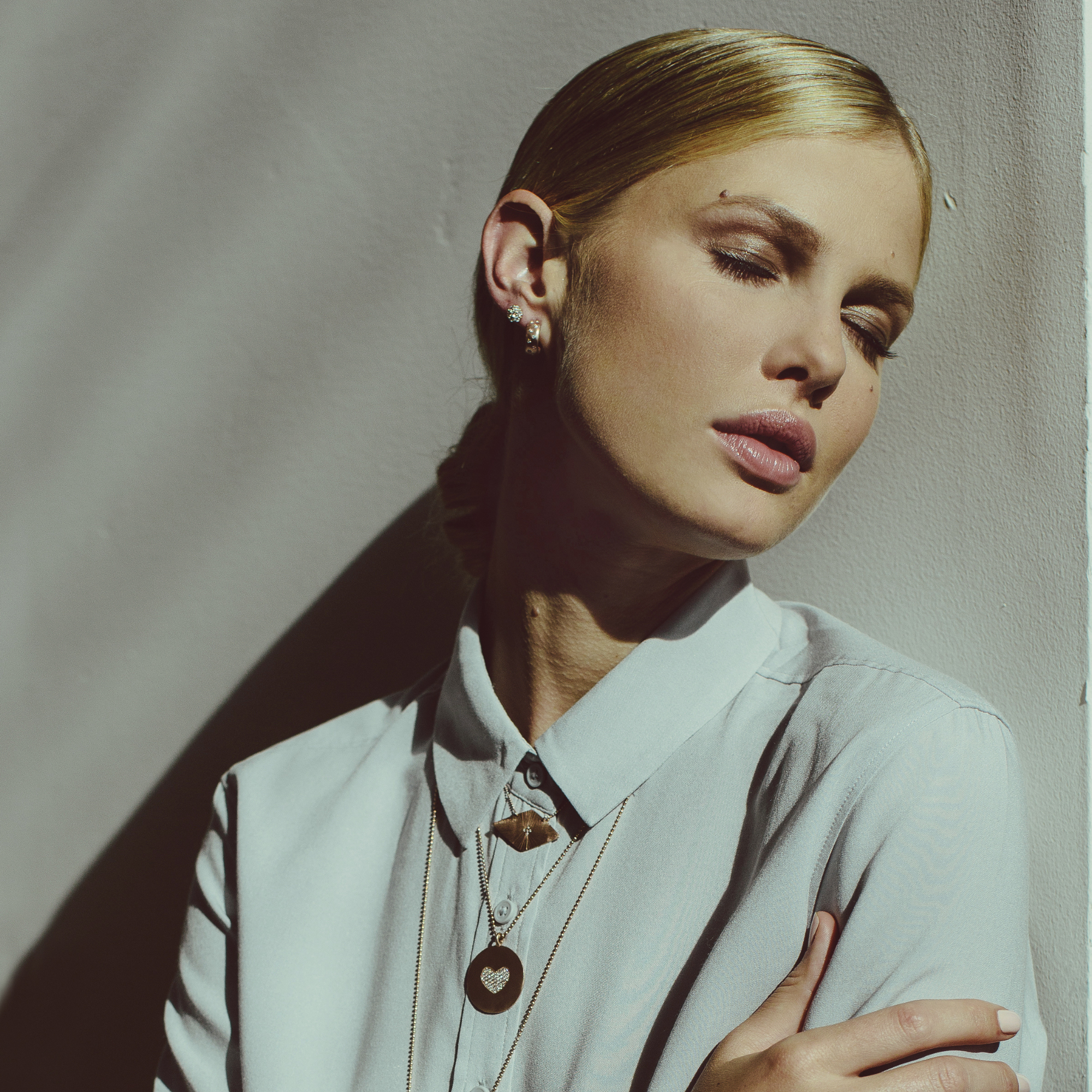 14k gold diamond cluster stud earrings on model in lifestyle shot