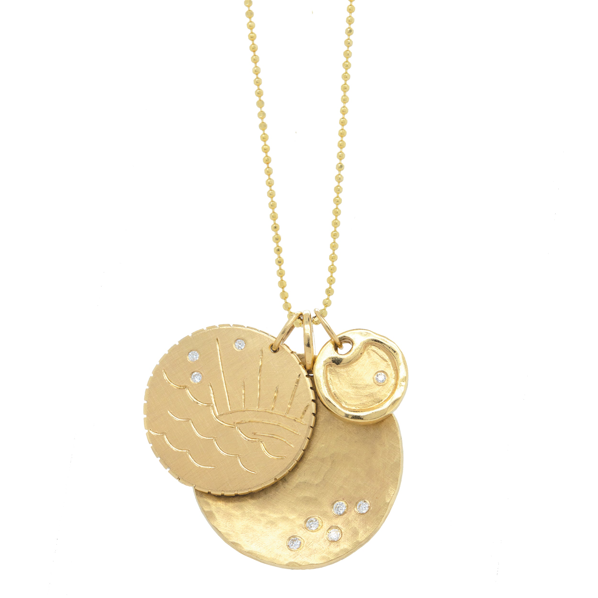 14k yellow gold round charm with ocean etching and white diamonds stacked with baby round charm with offset white diamond stacked with hammered round medallion with white diamond accents on white background