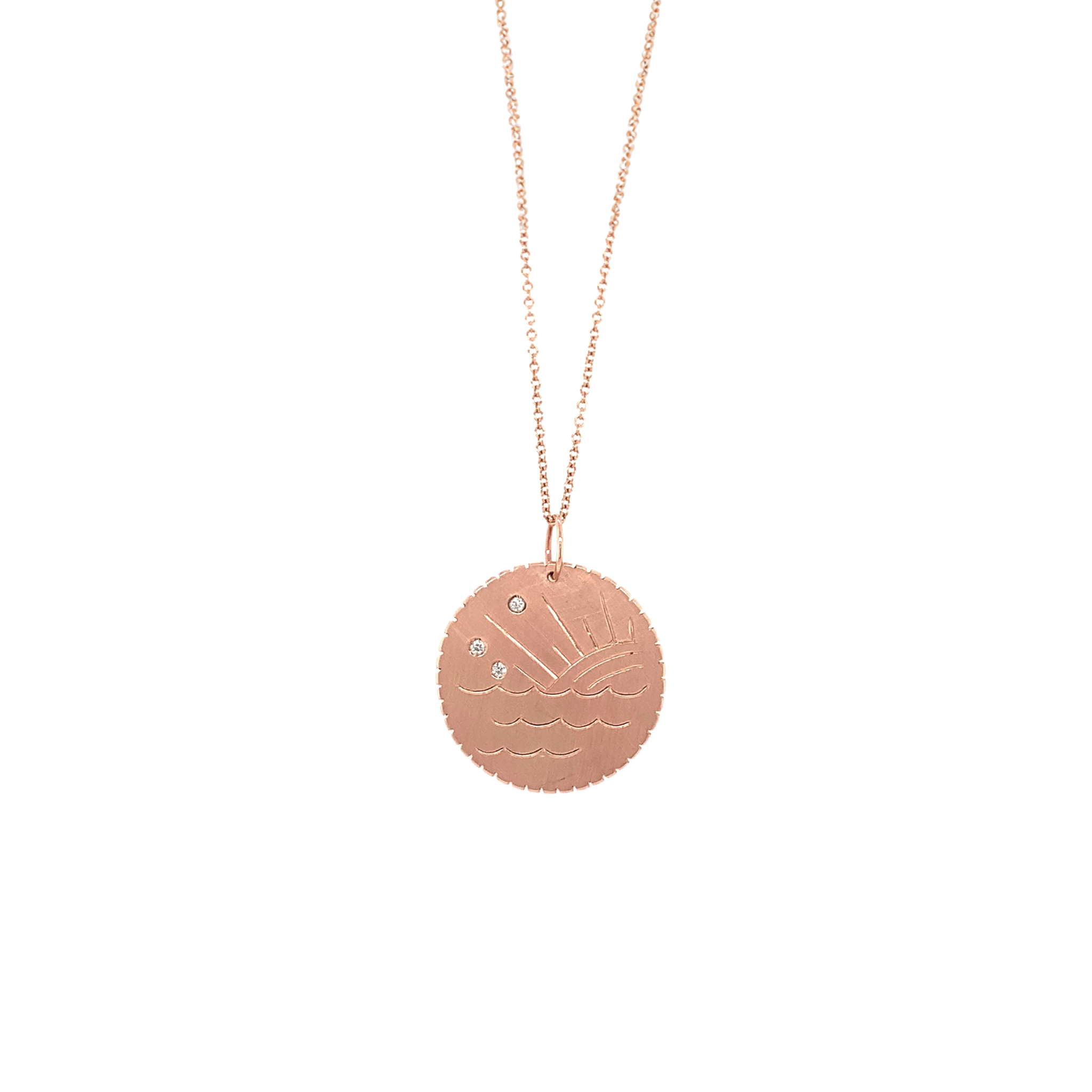 14k rose gold round diamond disk pendant necklace featuring hand engraved ocean waves and sun ray design scattered white diamonds in the sky and notched detail around edge shown hanging from round link rose gold chain on white background