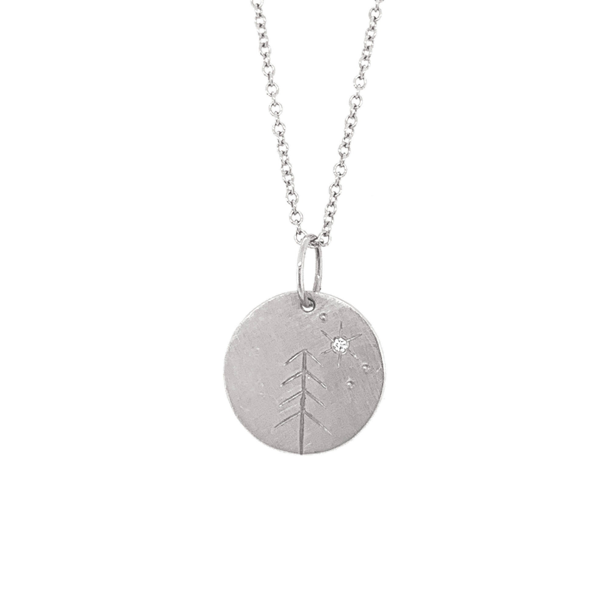 14k white gold round pendant featuring hand etched tree design and white diamond sunburst on rolo chain on a white background