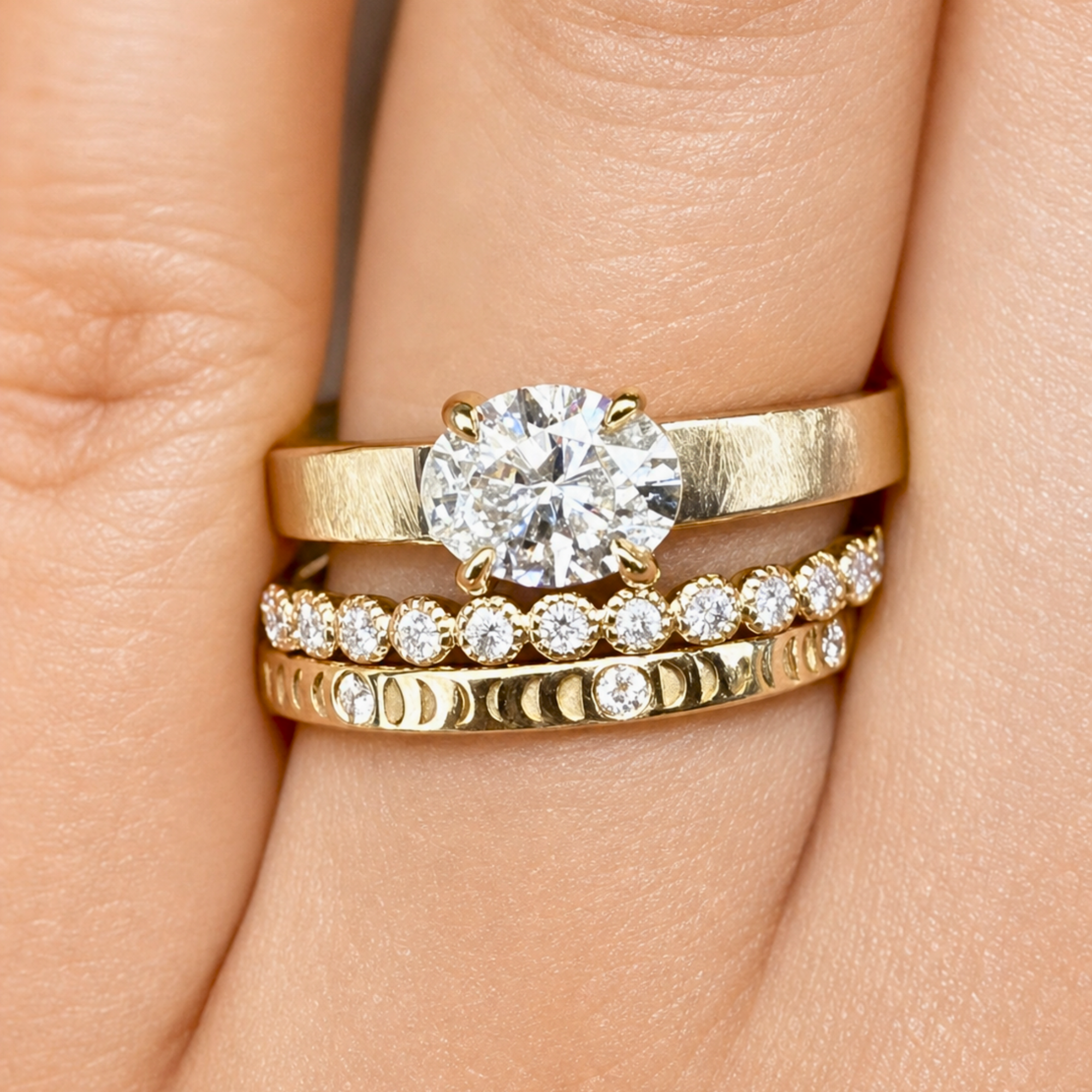Image of a lab grown oval east west prong set solitaire in 14k yellow gold engagement ring candid on a models hand.