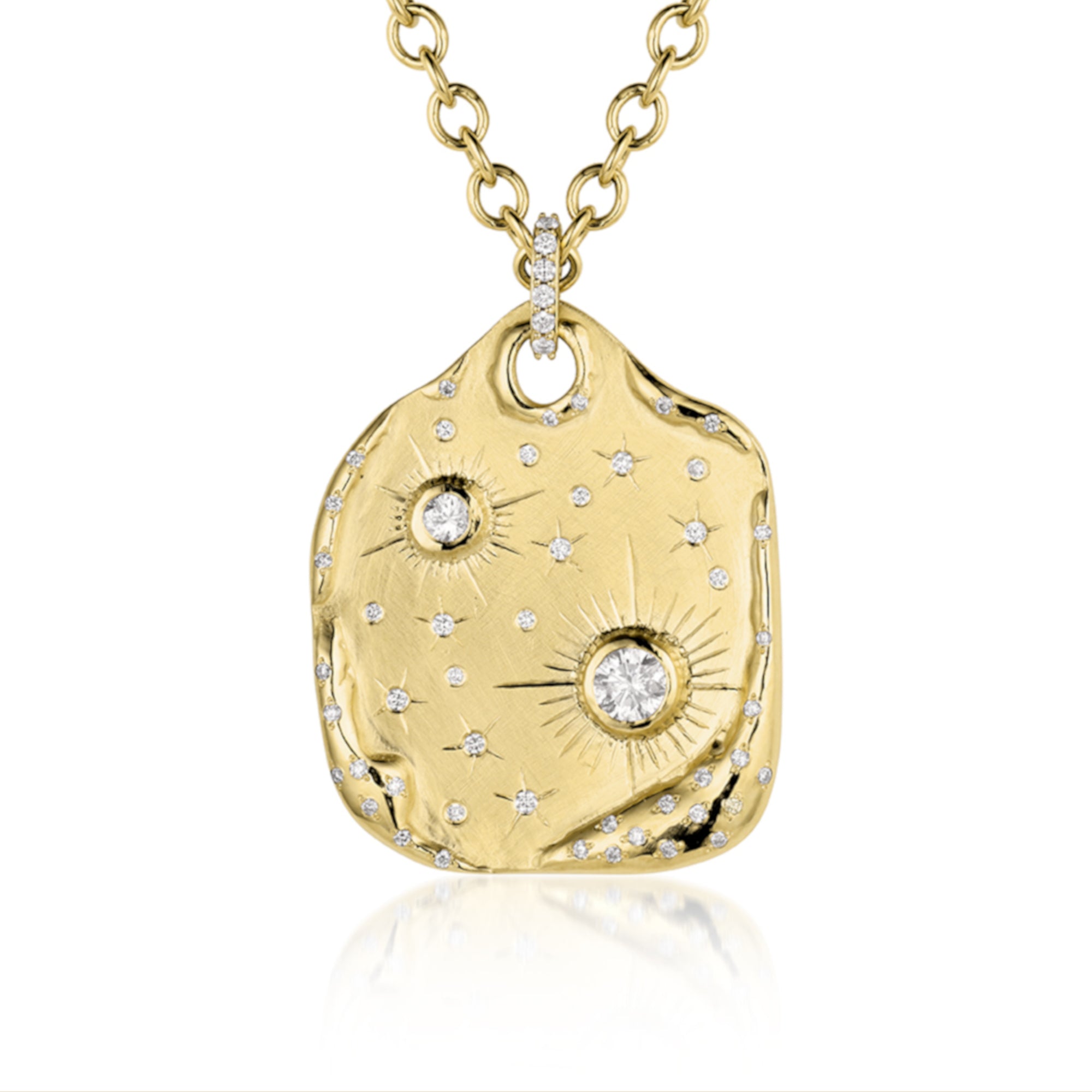 Extra large 14k gold pendant necklace with white Diamonds. Cosmic motif with bezel and flush set white diamond and sapphire stars with hand engraved details. Pave diamond bale hanging on a round link chain, on a white background.