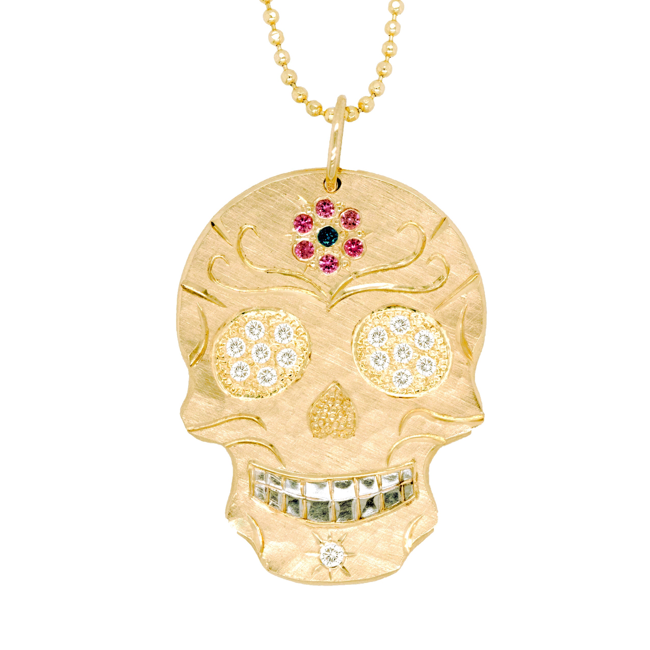 Large 14k gold hand cut skull pendant necklace with pink and blue sapphire  flower on forehead , white diamond eyes on a white background