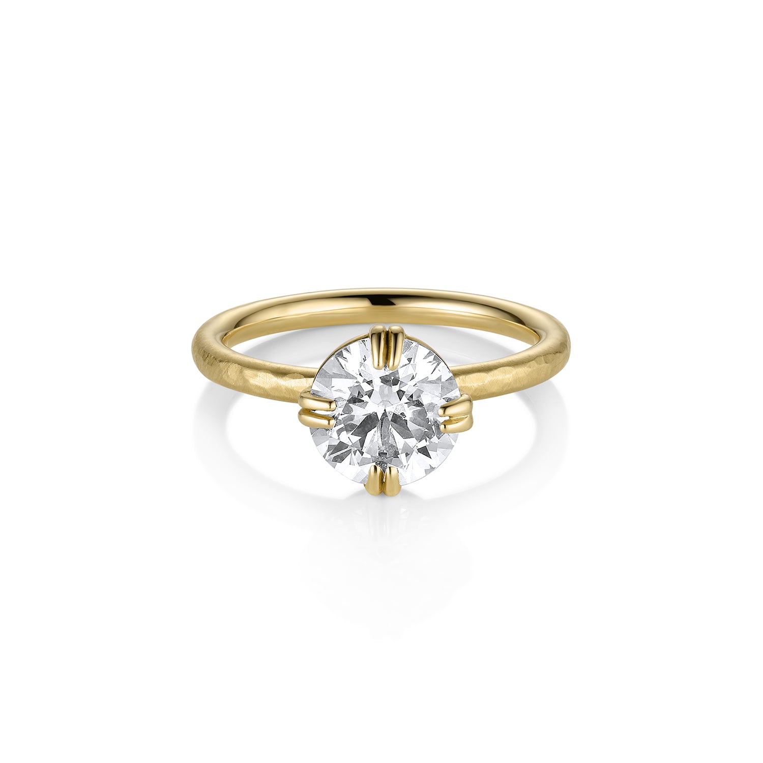 A 14k gold solitaire engagement ring with a bezel prong setting featuring an old Euro cut white diamond on a thin band with a satin finish.
