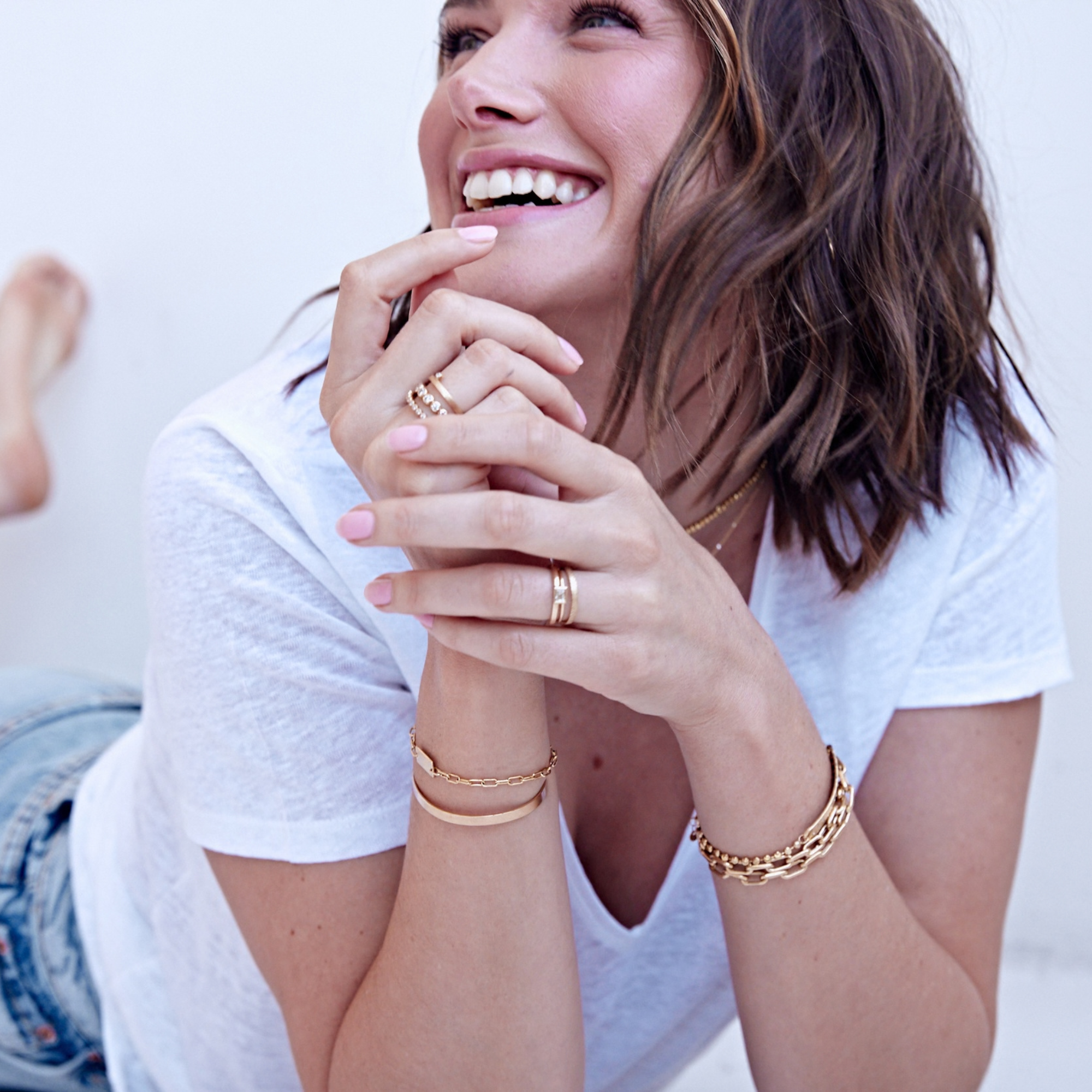 14k gold mica thick paperclip link bracelet stacked with other julez bryant bracelets on model in lifestyle shot