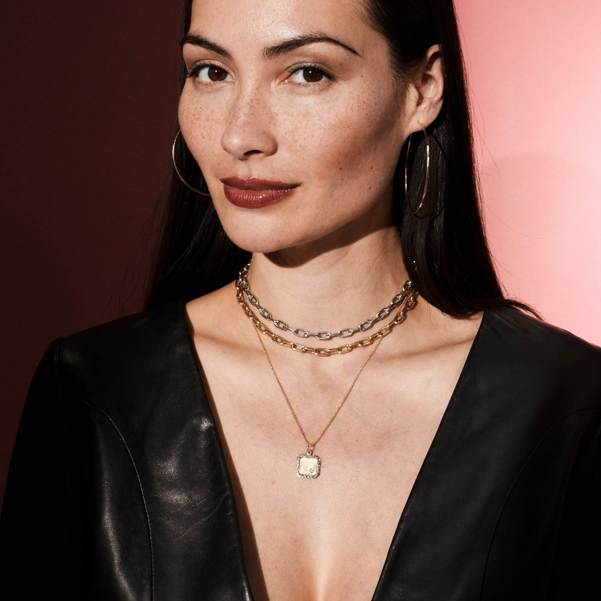 14k gold stacked necklace lifestyle shot with white gold mica chain and yellow gold mica chain and a square dogtag pendant with shiny and satin finishes and an offset white diamond on model