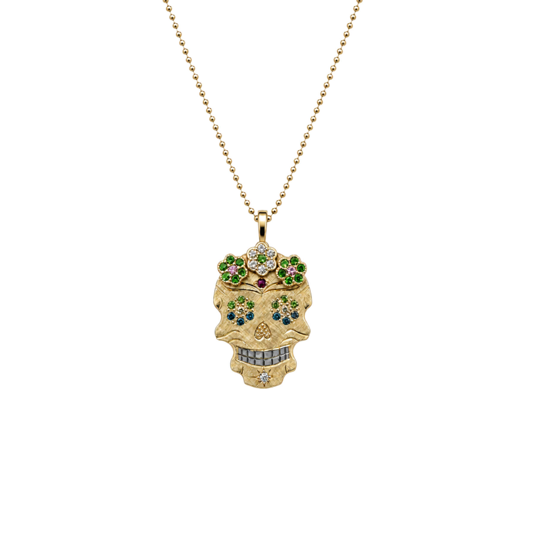 A gold sugar skull pendant necklace adorned with colorful gemstones, hanging from a gold ball chain against a plain white background.