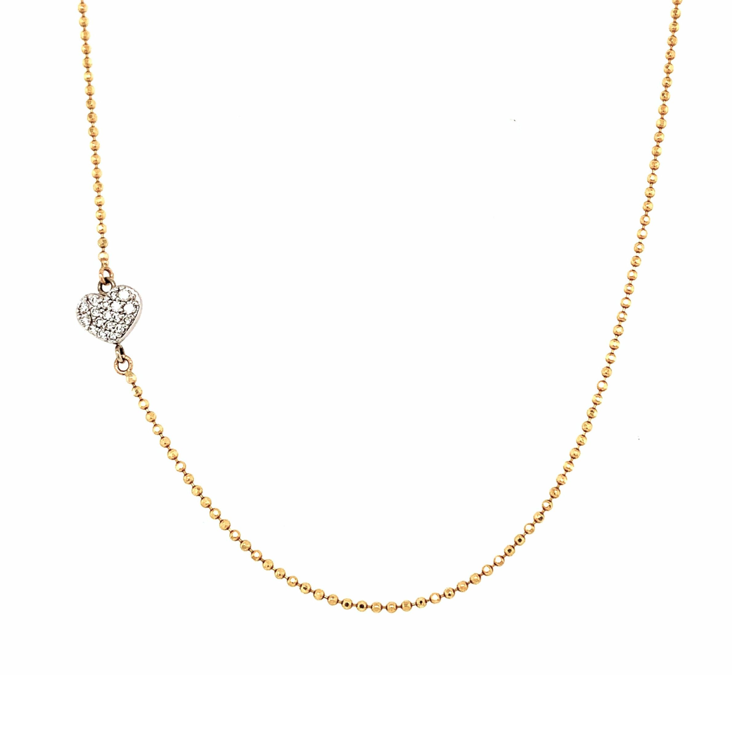 Yellow gold necklace with a pave white diamond heart-shaped station pendant and diamond cut ball chain on a white background