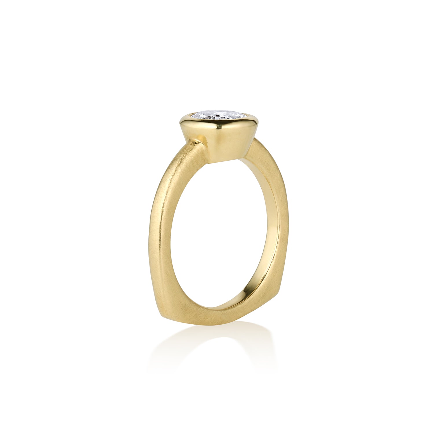 Solitaire yellow gold ring with single stone bezel set on unique shaped shank, side view on a white background