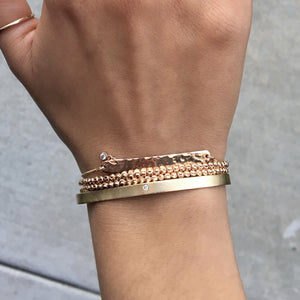 14k gold PARI bar bracelet with diamond dangle on model with MOCA double wrap and BOLI bracelet