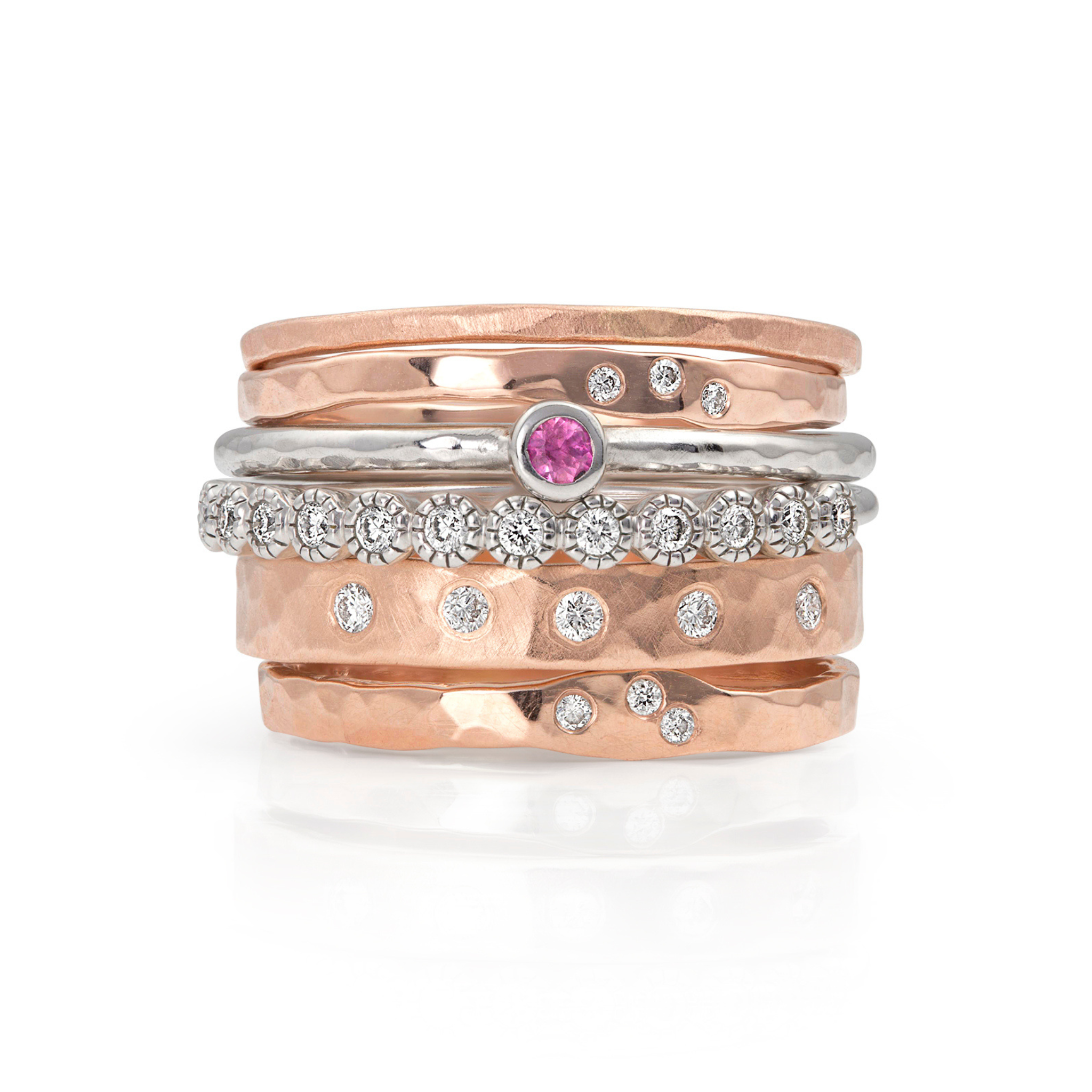 14k rose gold stackable hammered ring with small white diamonds stacked with other julez bryant rings on a white background