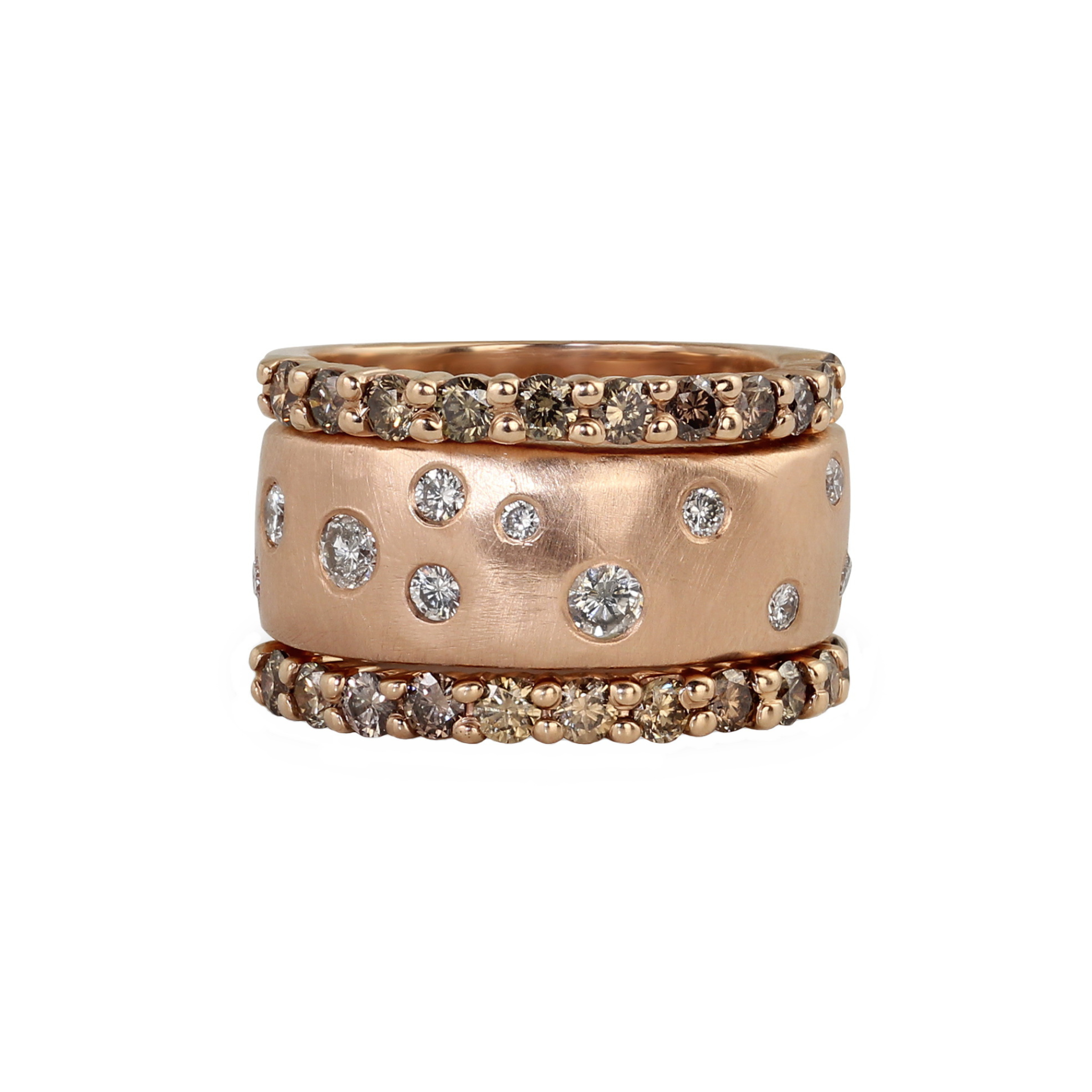 Stacked rings featuring thick heavy weight wide 14k rose gold wedding band ring with scattered white diamonds embedded all the way around surface brushed satin texture shown layered between two cognac diamond eternity bands shown on white background