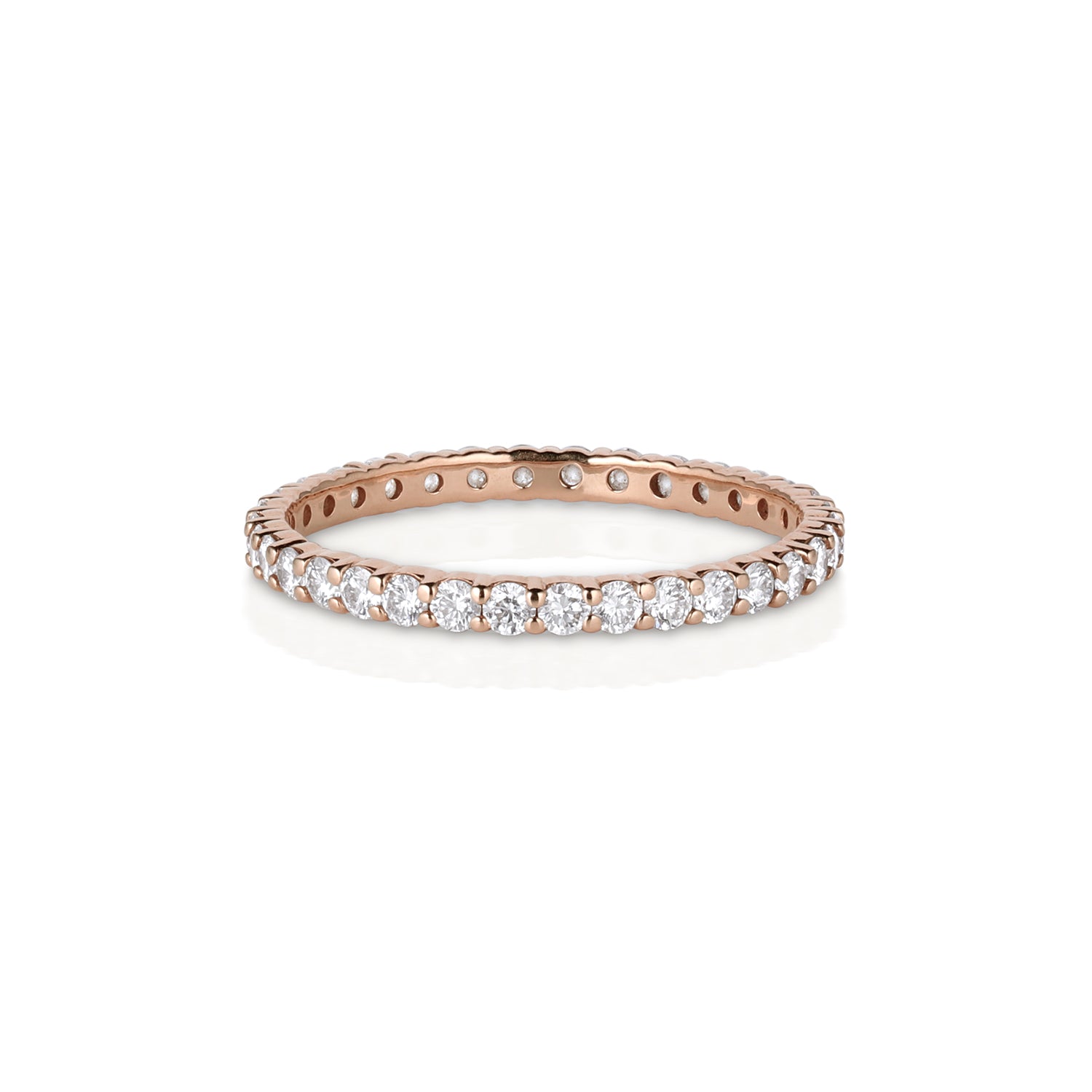 Rose gold ring with small round white diamonds prong set eternity wedding band on a white background