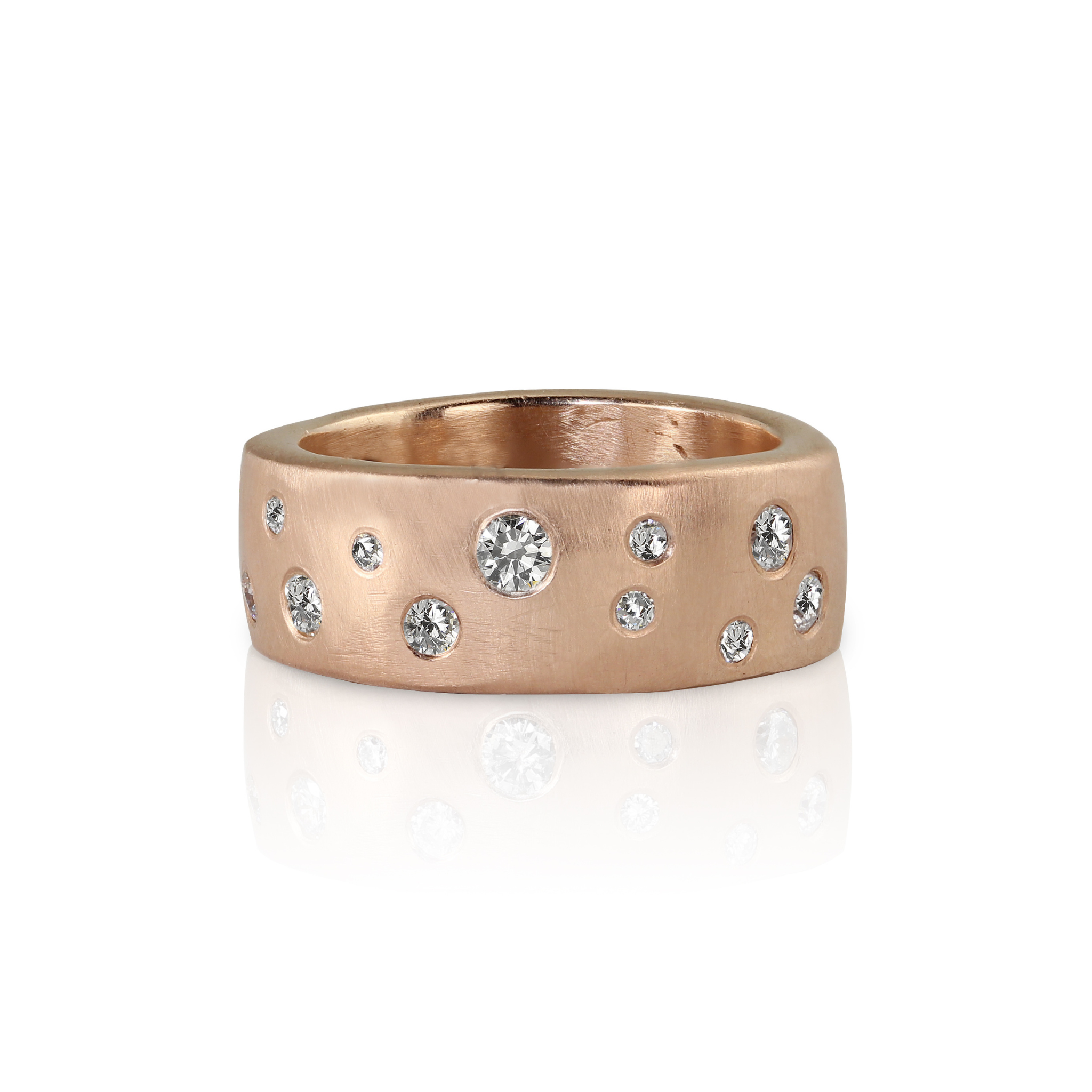 Thick heavy weight wide 14k rose gold wedding band ring with scattered white diamonds embedded all the way around surface brushed satin texture shown on white background