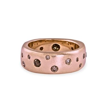 Rose gold wide band ring with sacattered embedded cognac colored diamonds on white background 