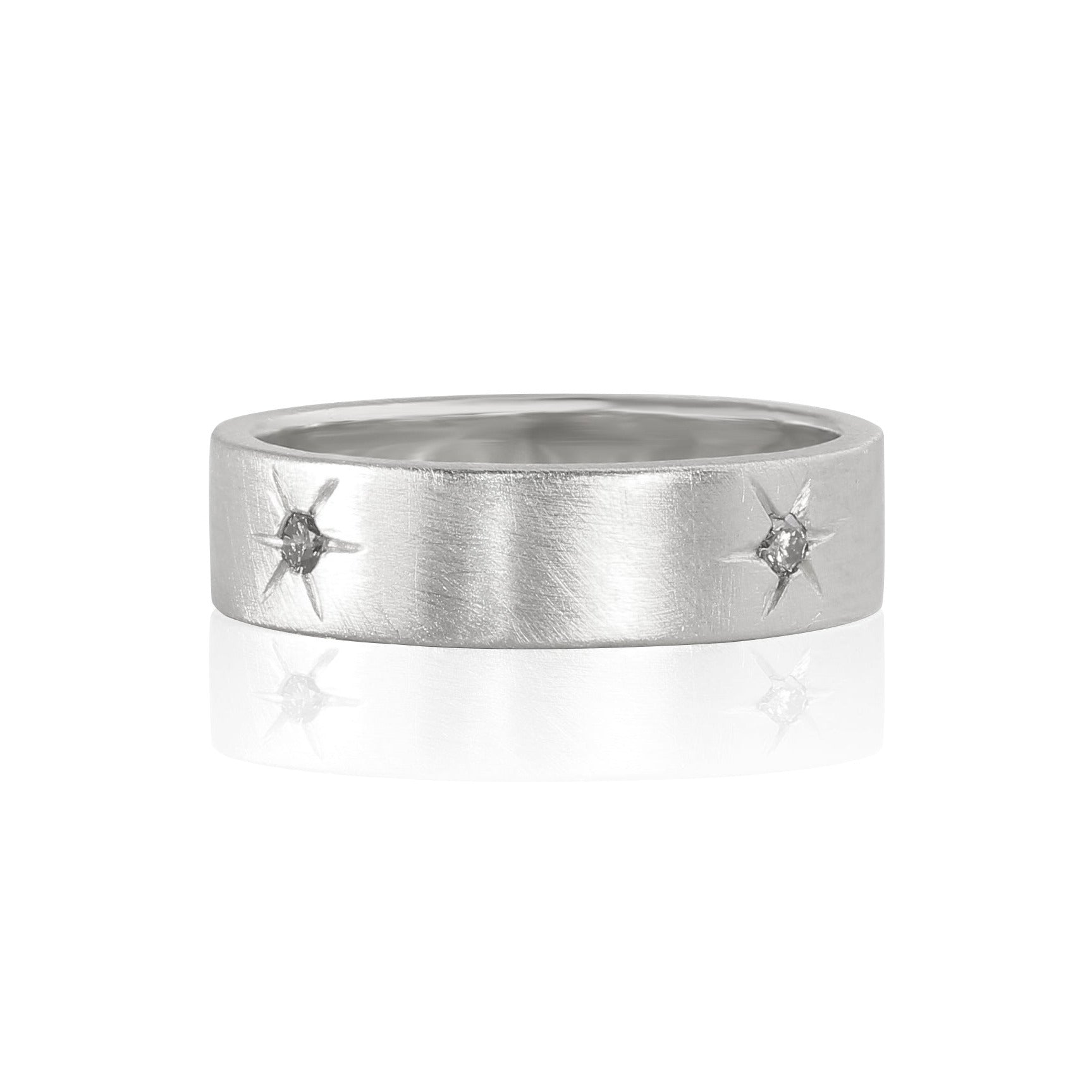 14k white gold ring with embedded white diamonds and engraved starburst details encircling band satin brushed finish shown laying flat on a white background