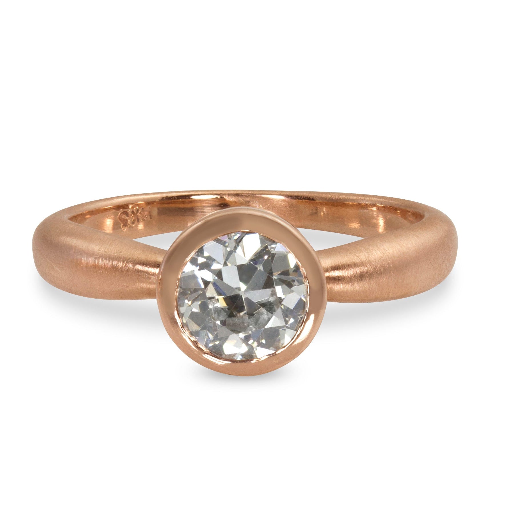 Rose gold single stone solitaire round white diamond engagement ring with bezel setting satin finished puffed band on white background