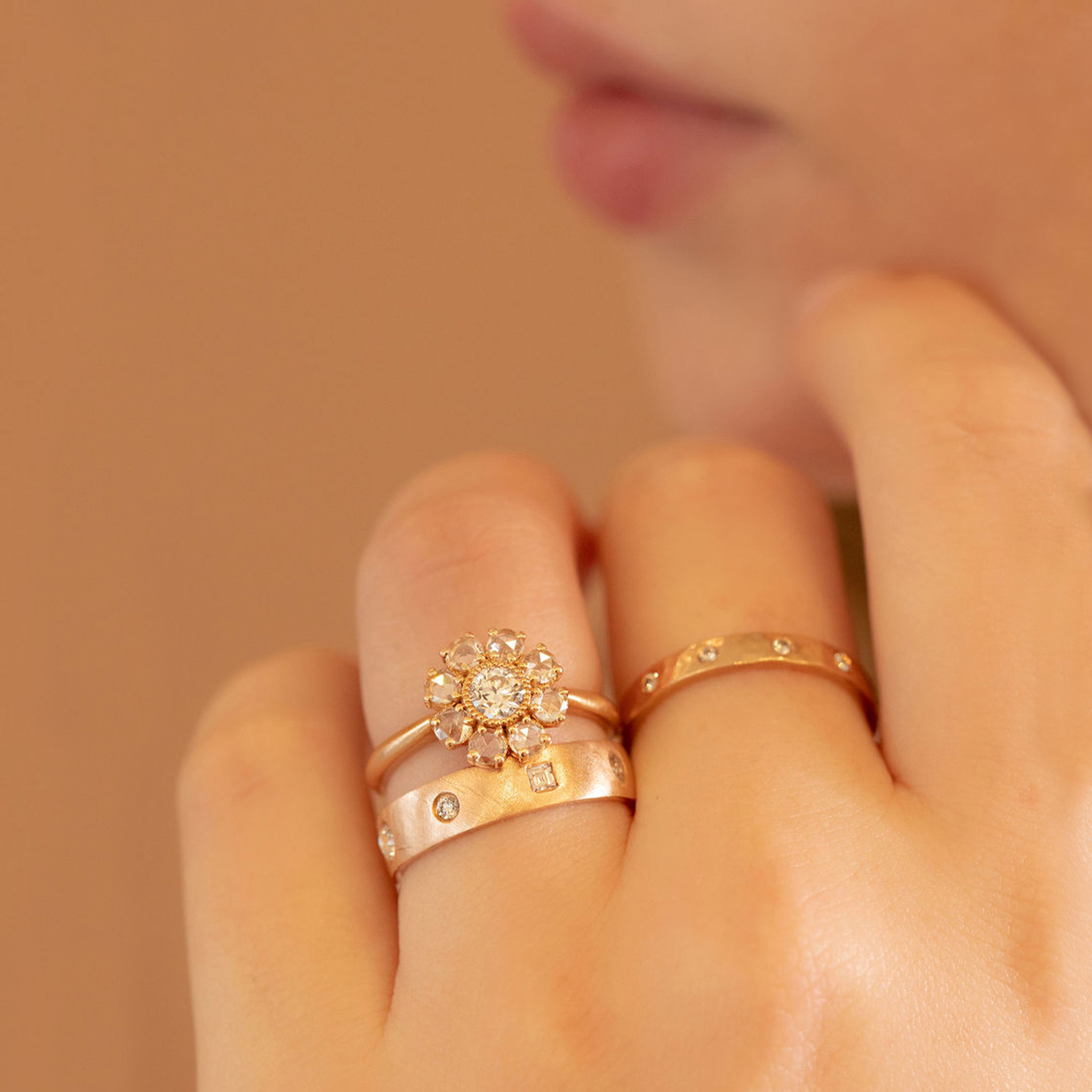 14k yellow gold stackable hammered ring with small white diamonds on a model in lifestyle shot