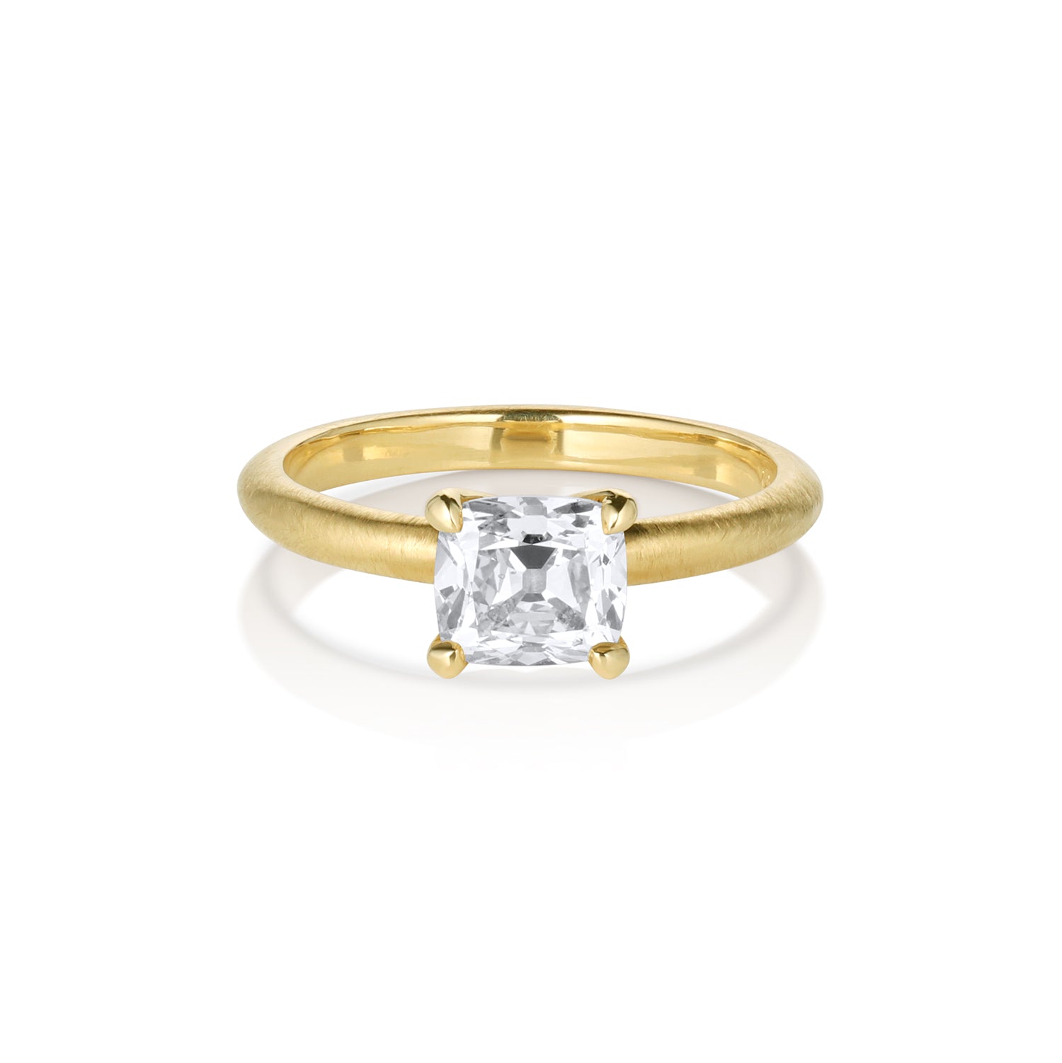 Gold ring with a square-cut diamond on a white background