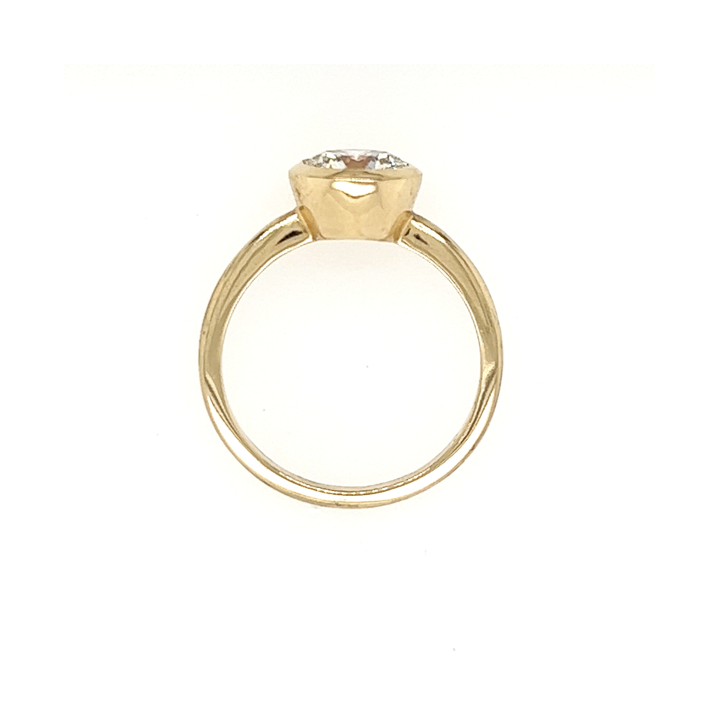 14k yellow gold ring with a bezel set diamond side view on a white background