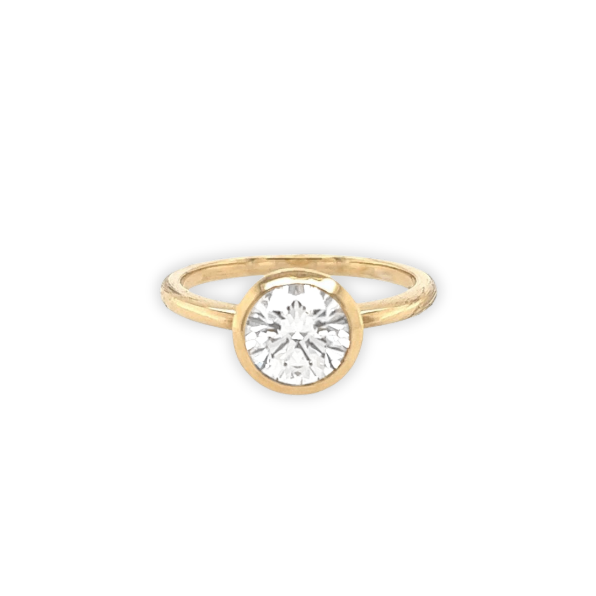 14k yellow gold ring with a bezel set diamond on a white background