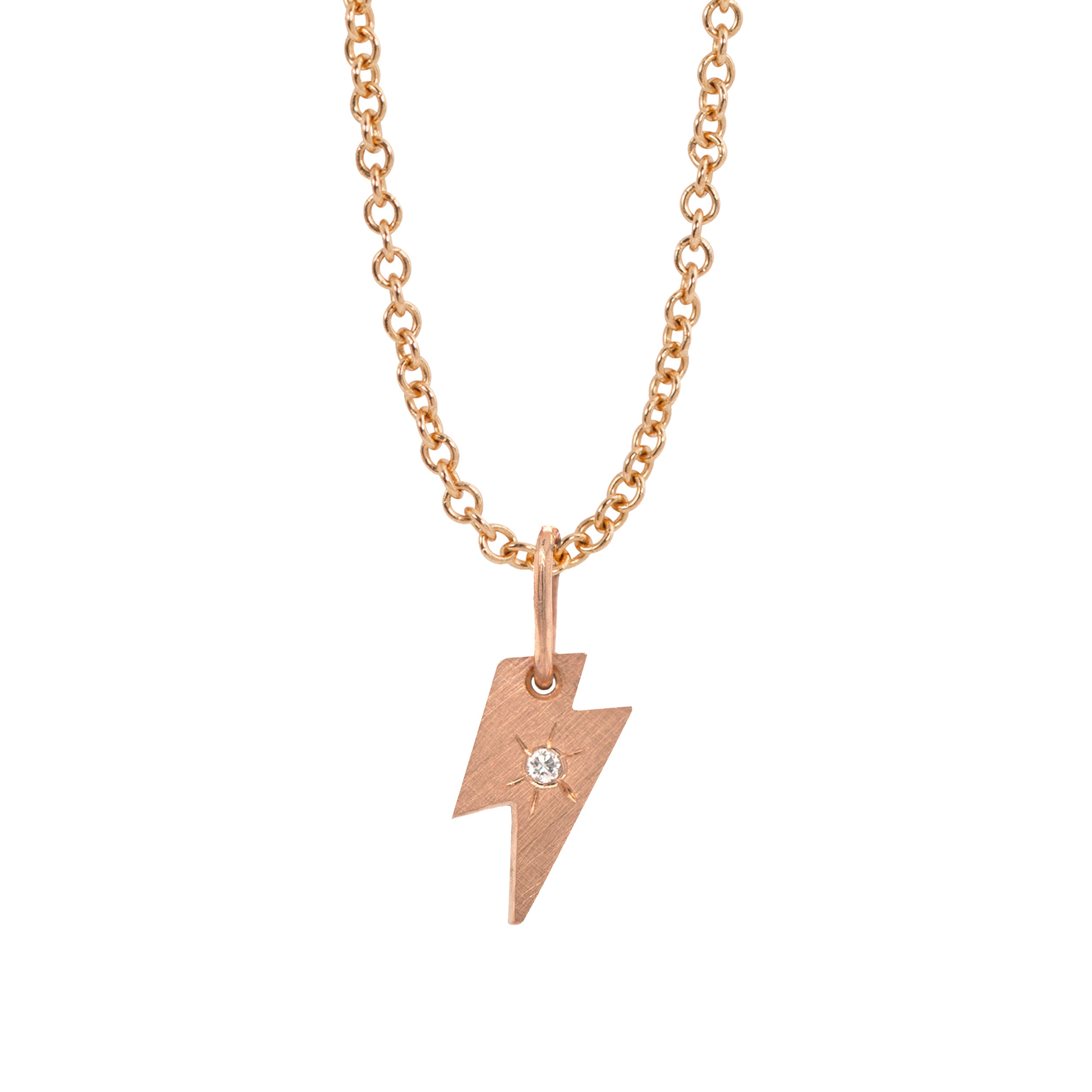 14k rose gold lightning bolt pendant with white diamond and hand etched starburst on a white background