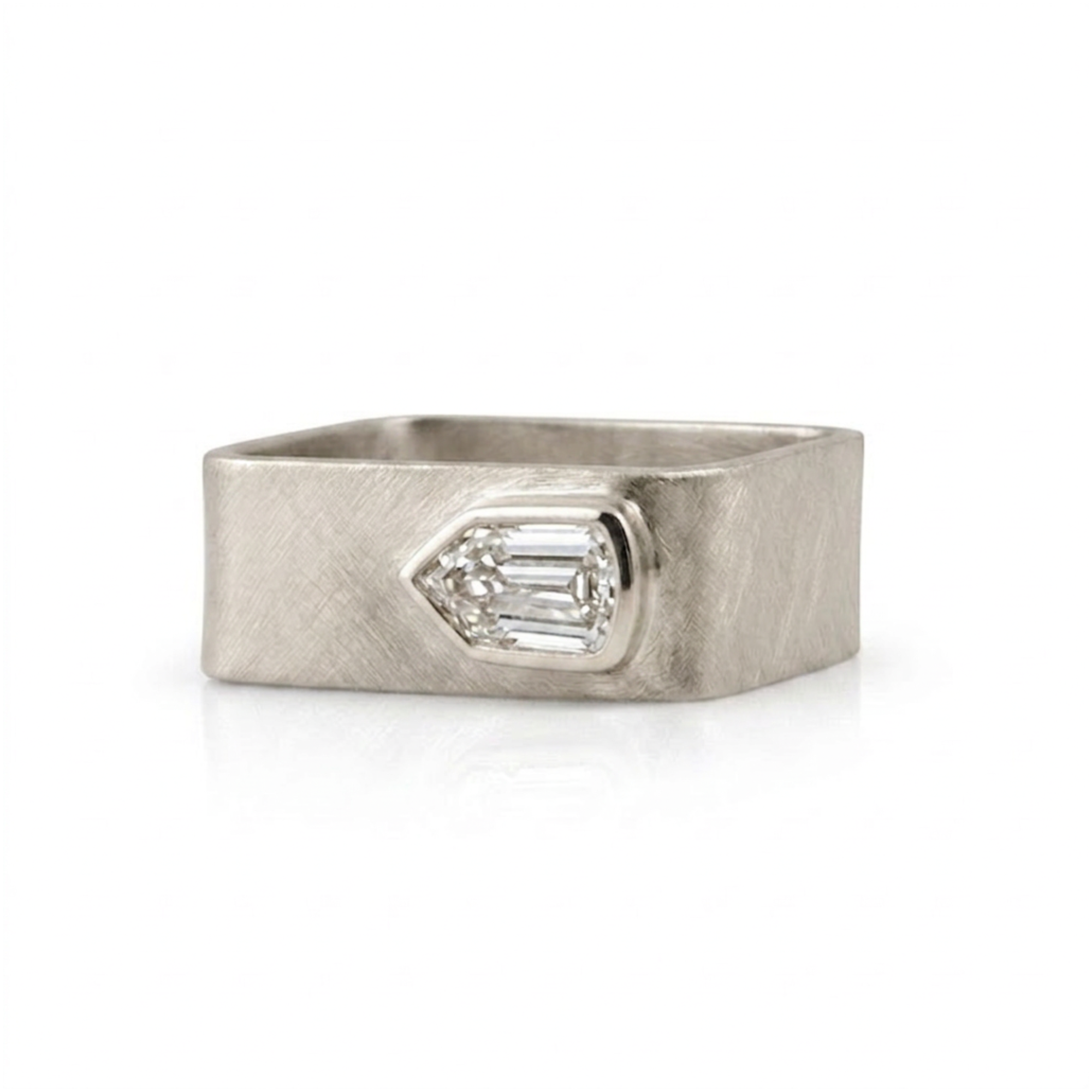 Wide band geometric shield cut diamond bezel solitaire ring in 14k white gold, front view on a white background