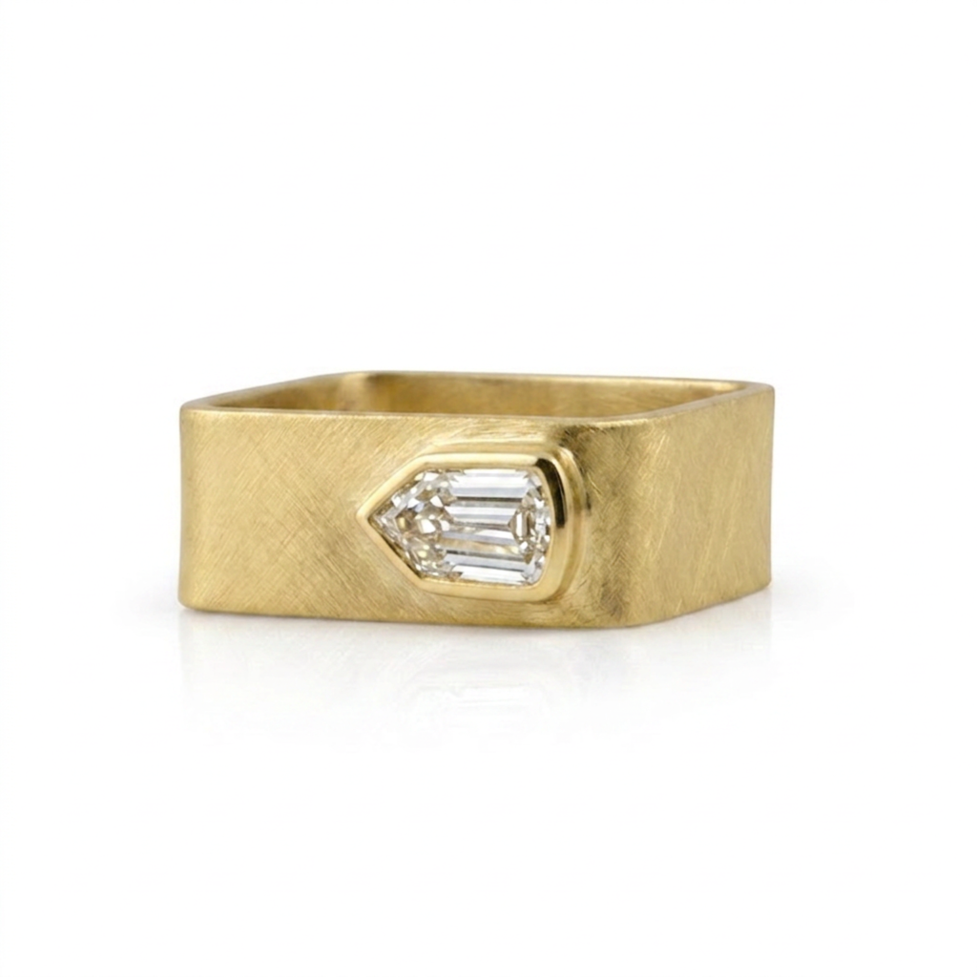 Wide band geometric shield cut diamond bezel solitaire ring in 14k yellow gold, front view on a white background