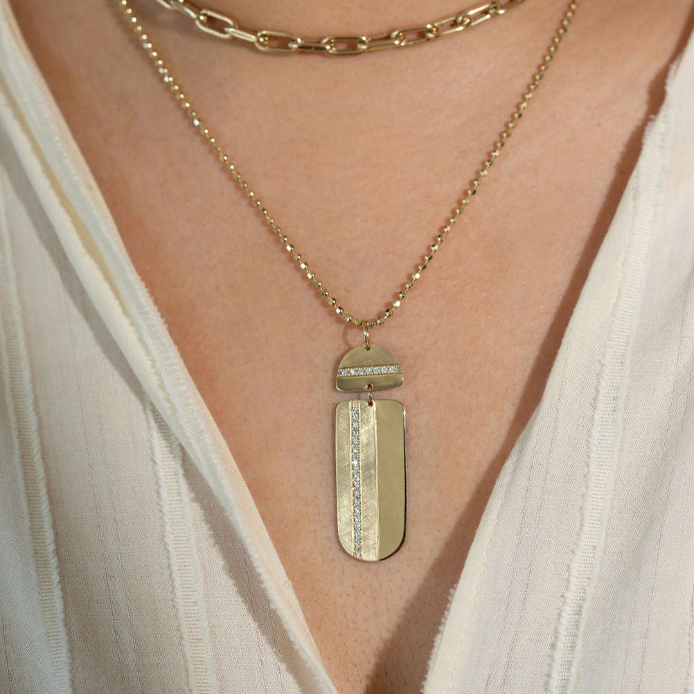 14k yellow gold large vertical bar pendant with complimenting shiny and satin finish and single row of white diamond accent