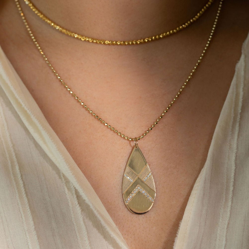 14k yellow gold JOMO x-large tear drop pendant with alternating shiny and satin finish and white diamond accent stripes