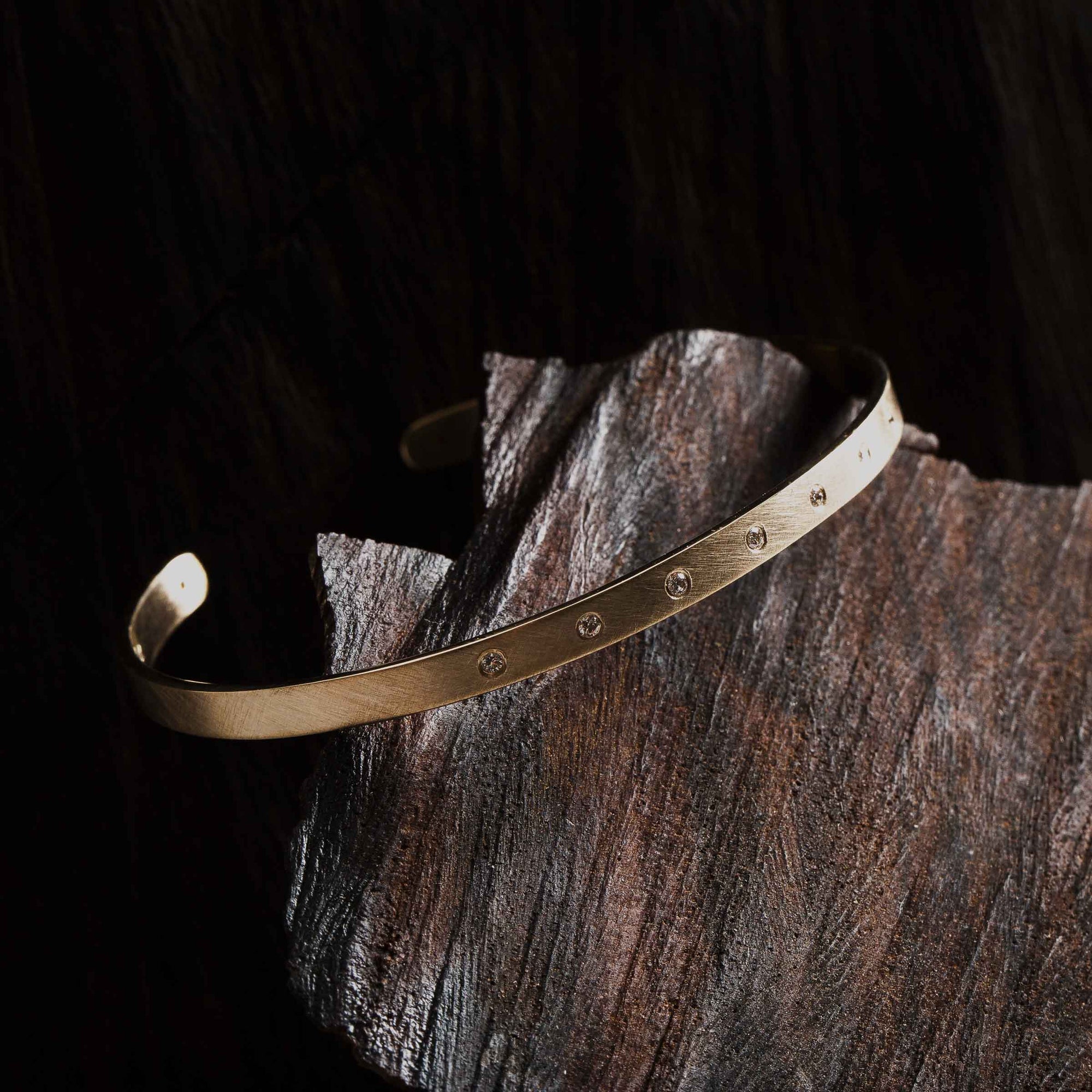 14k yellow gold BELA cuff bracelet with 7 diamonds in studio image