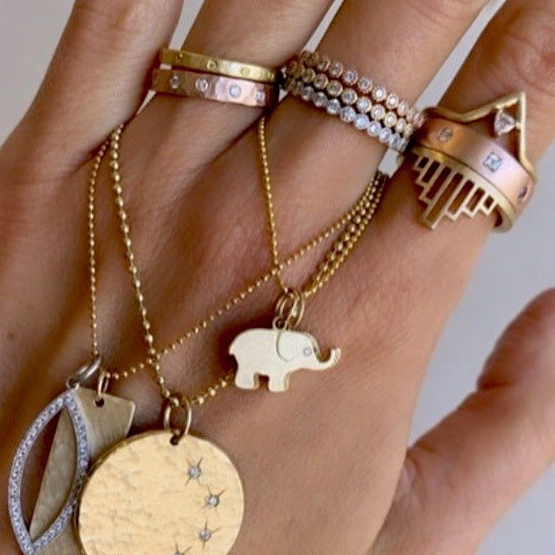 14k gold baby ELLO elephant charm on models hand