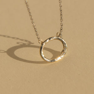 14k gold GOOZ circle necklace with diamonds in studio