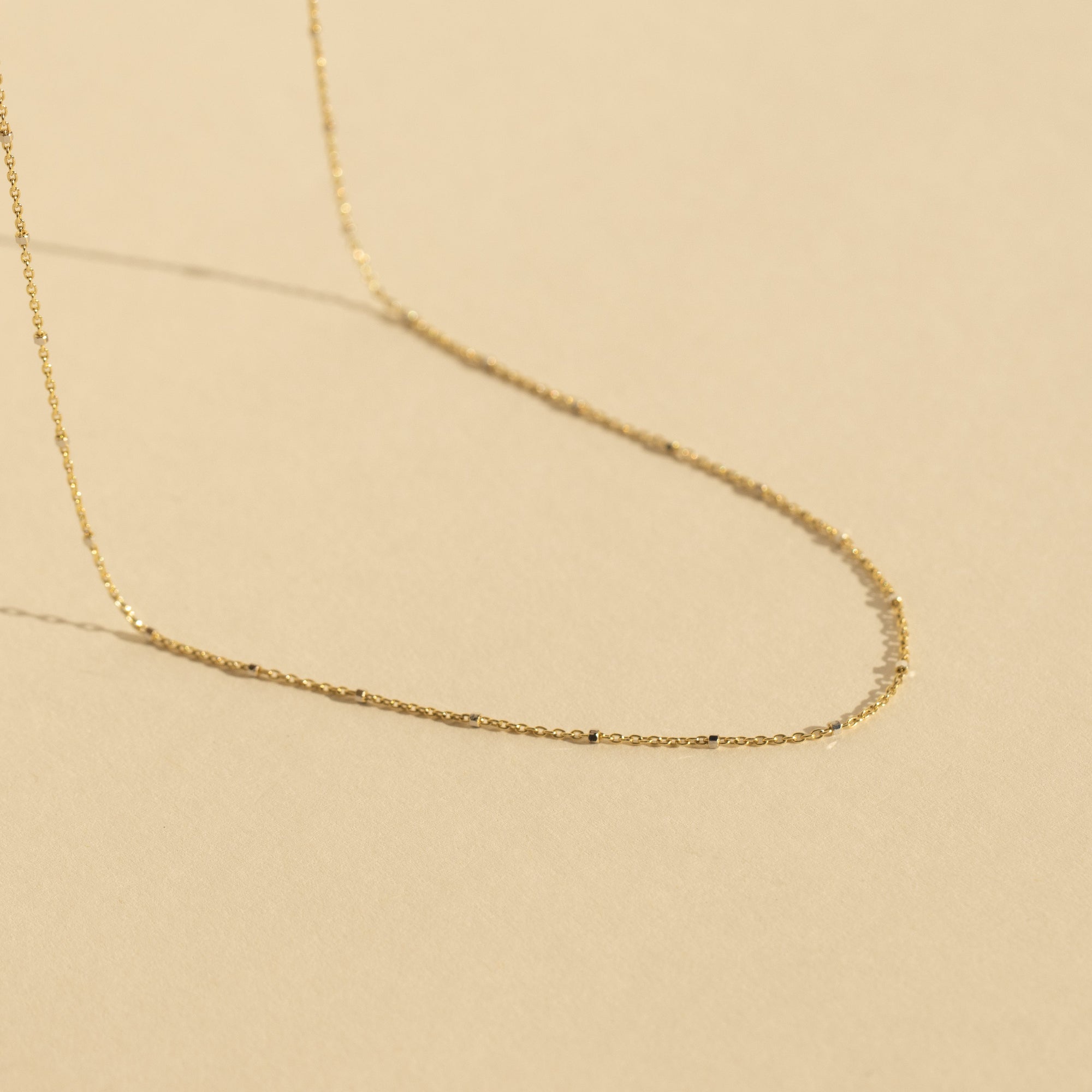 14k yellow gold 1.0mm rolo bead chain in studio image