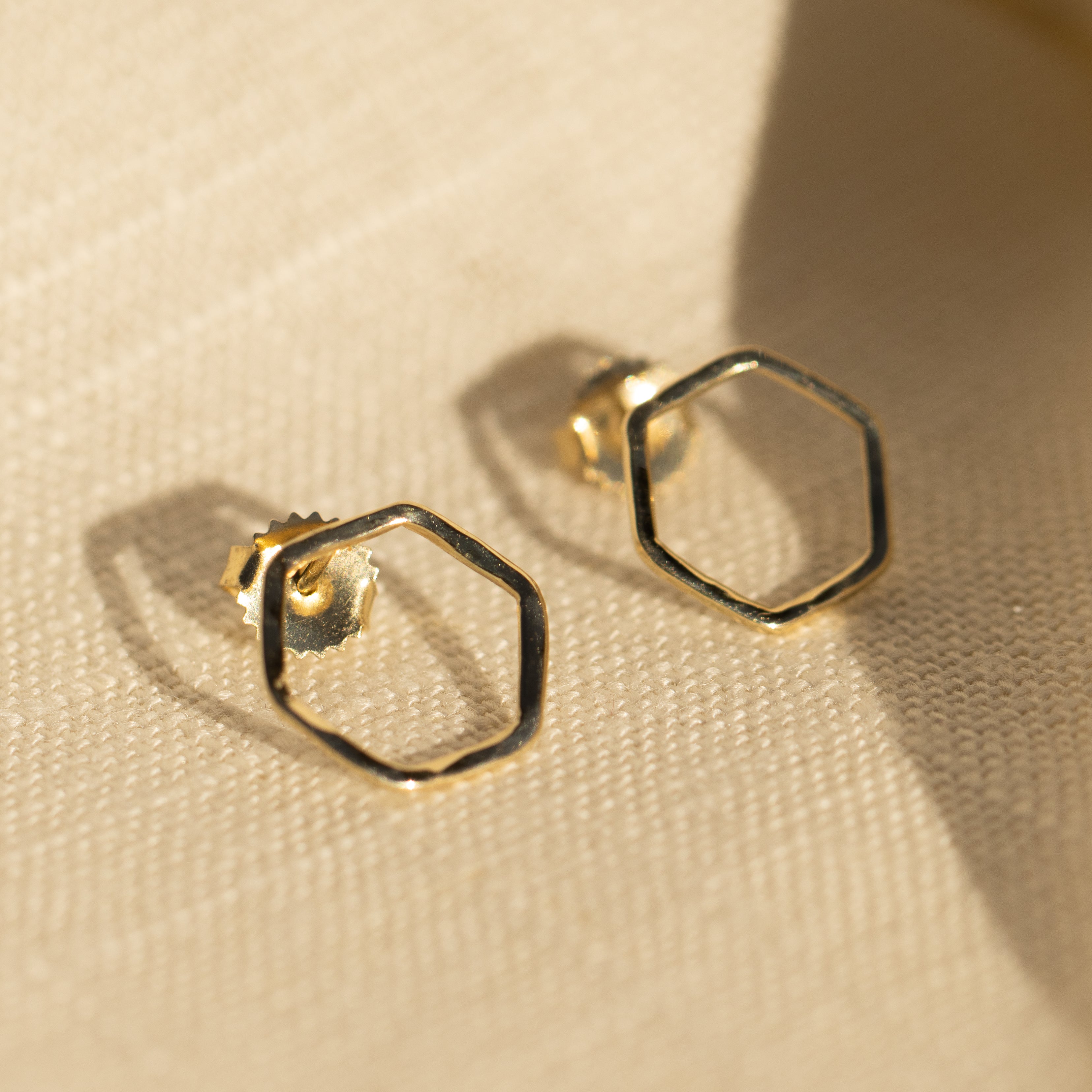 14k gold GOUL post earrings in studio