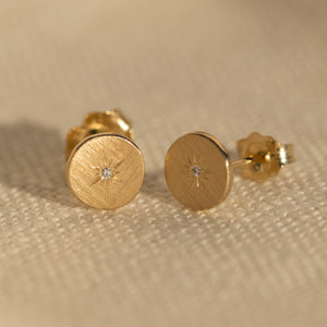 14k gold GORA post earrings in studio