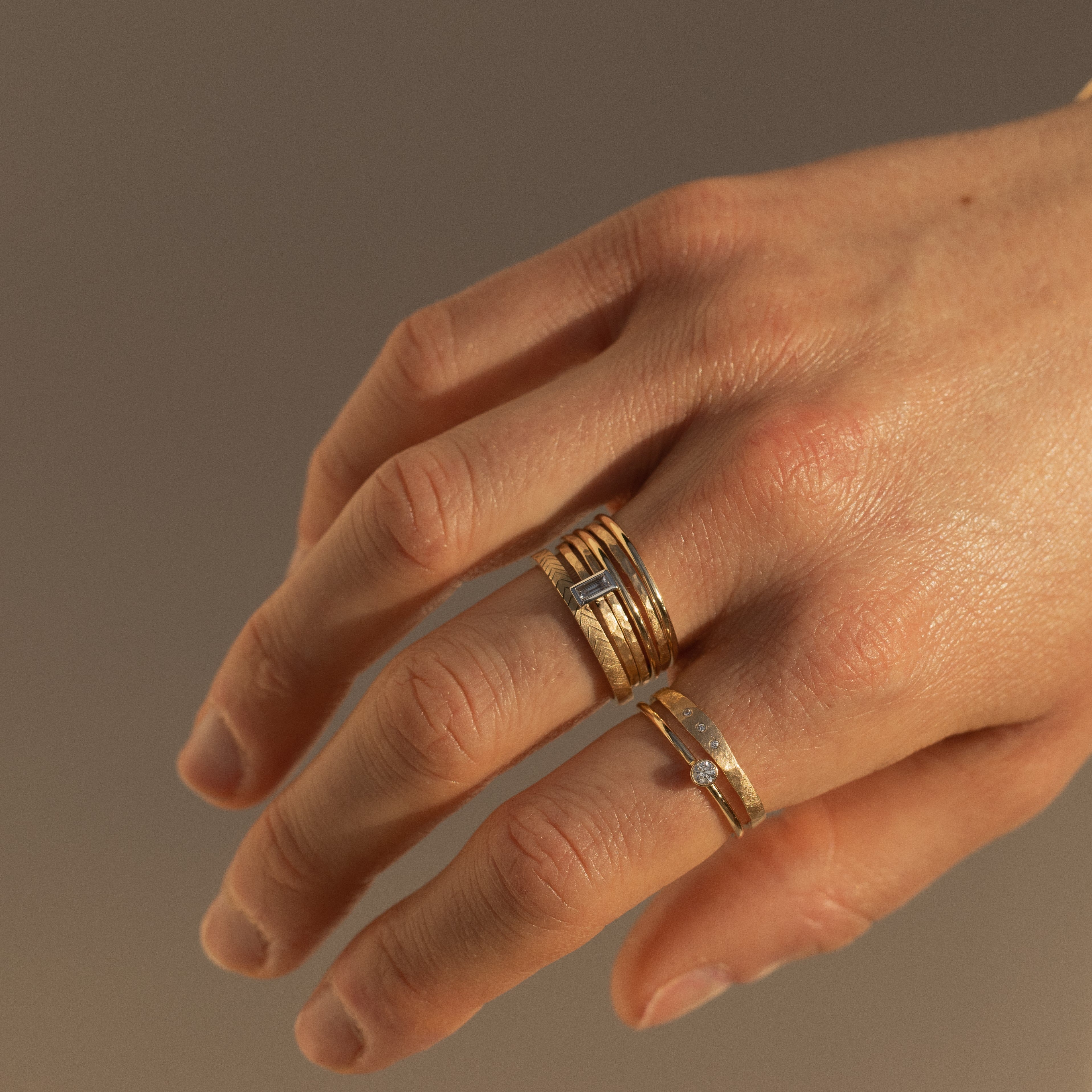 14k gold GELP baguette stacker ring on hand