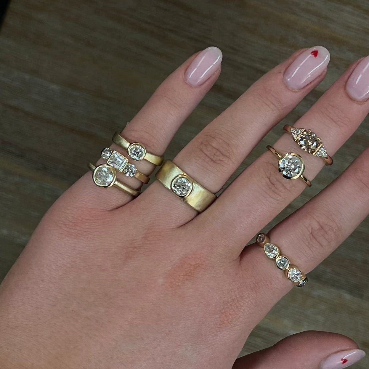 Model hand loaded with various gold and diamong rings.