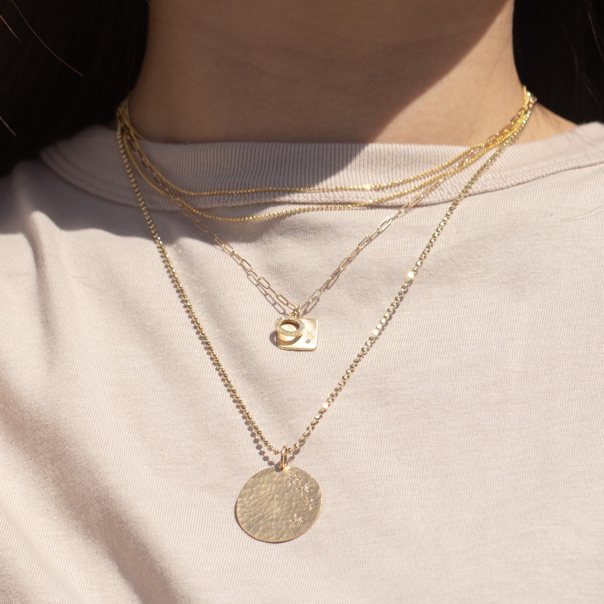 14k gold baby MORA square charm with one diamond layered with GINY diamond circle