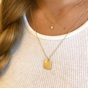 14k yellow gold LEAH square charm with diamond heart outline on model