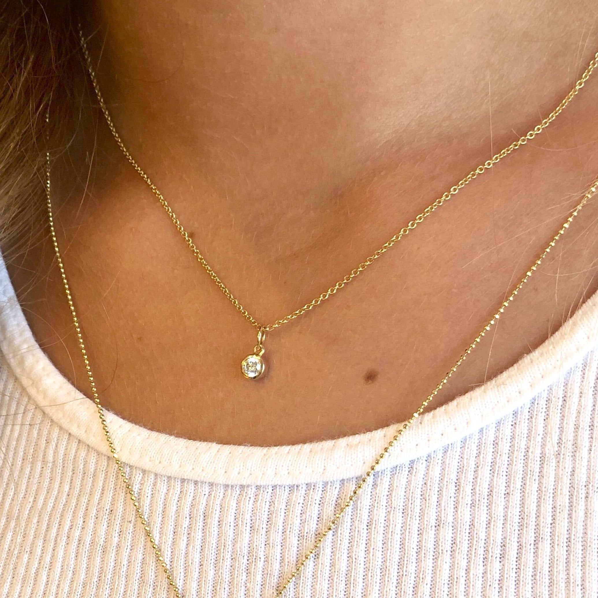 14k yellow gold OTTO diamond pendant in bezel setting on 1.0mm chain on model