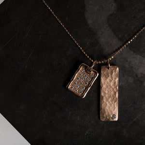 14k rose gold NIKI bar pendant with one diamond in studio image with DEFT dog tag