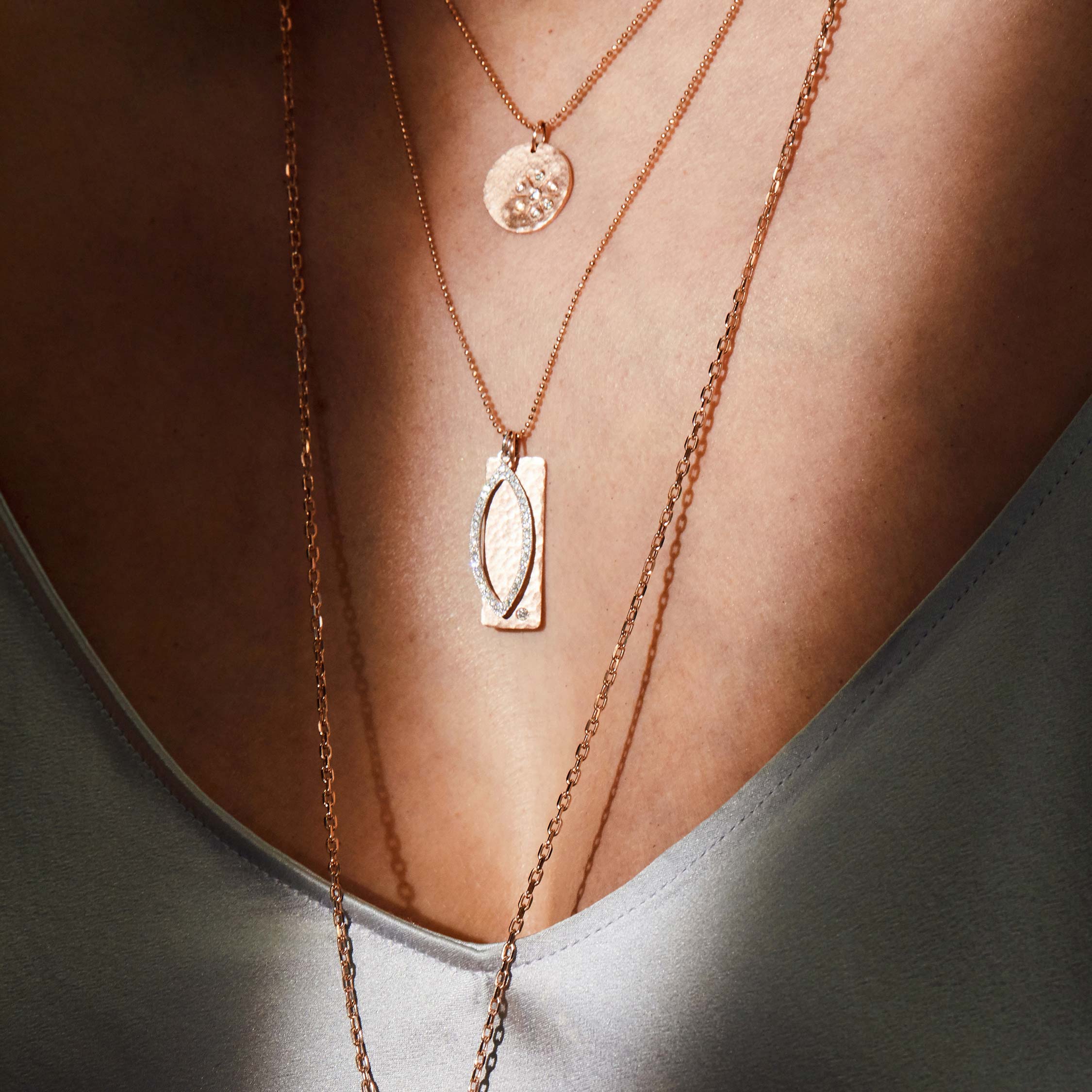 14k gold medium NIKI bar pendant layered with small EDIE on model